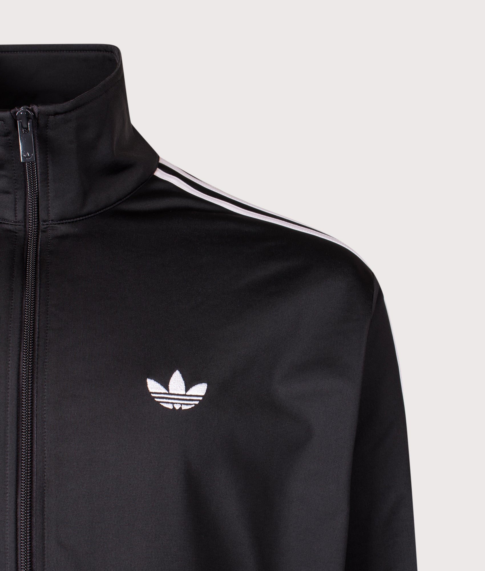 adidas Originals Firebird Track Top in Black at EQVVS Menswear. Detail shot.