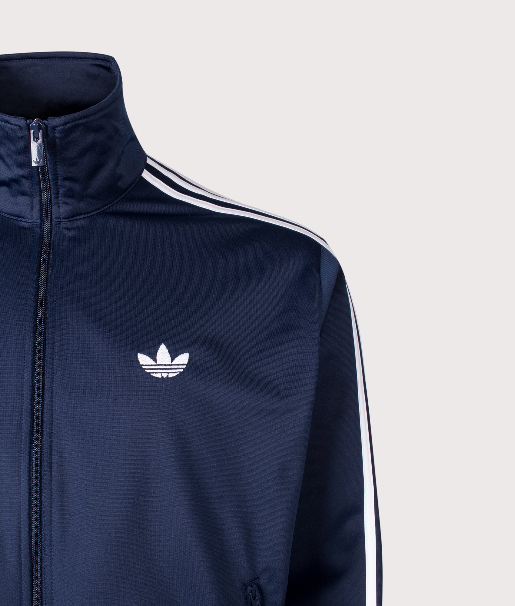 adidas Originals Firebird track top in Night Indigo at EQVVS Menswear. Detail shot. 