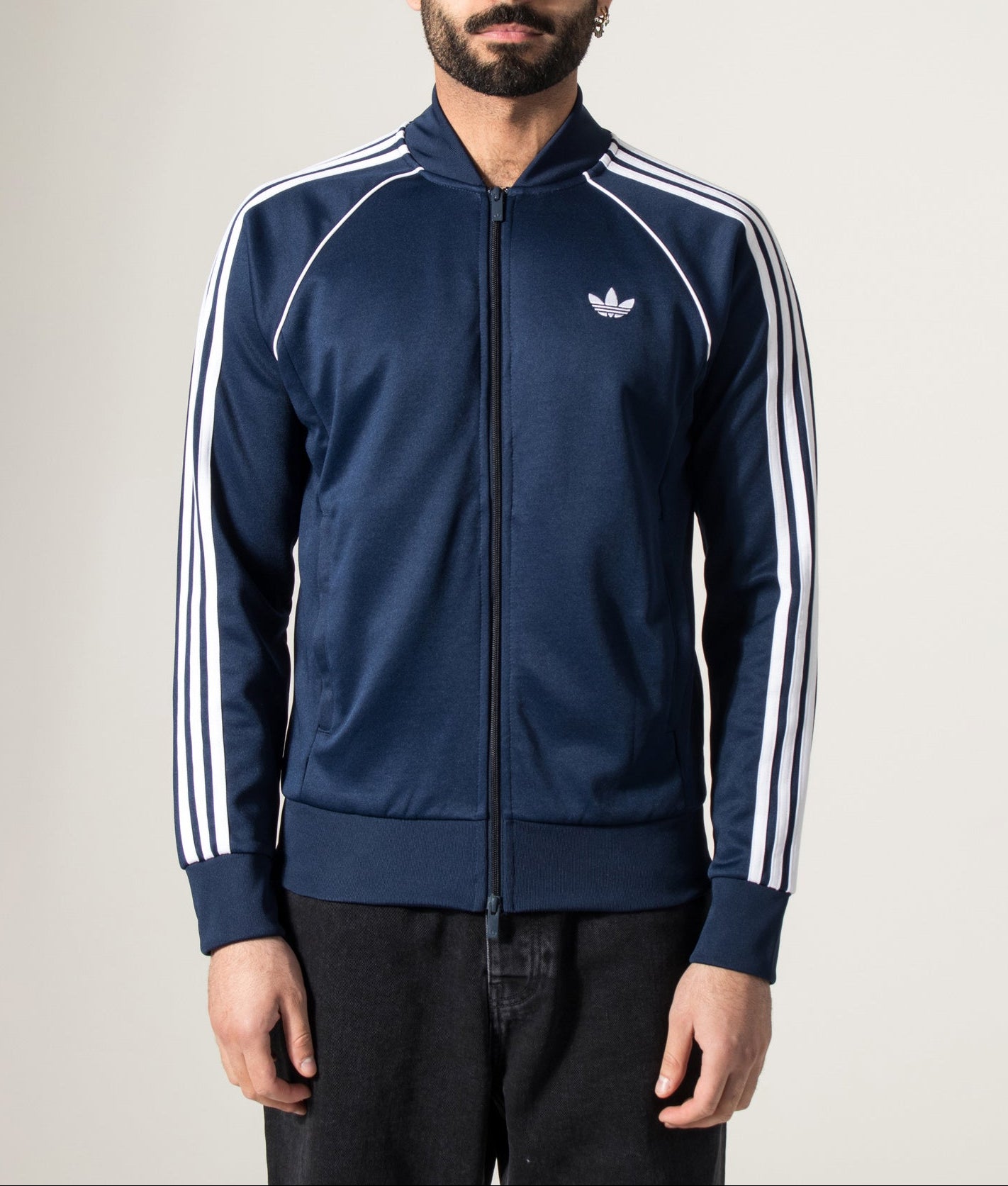 adidas Originals SST Track Top in Night Indigo at EQVVS Menswear. Model front shot.