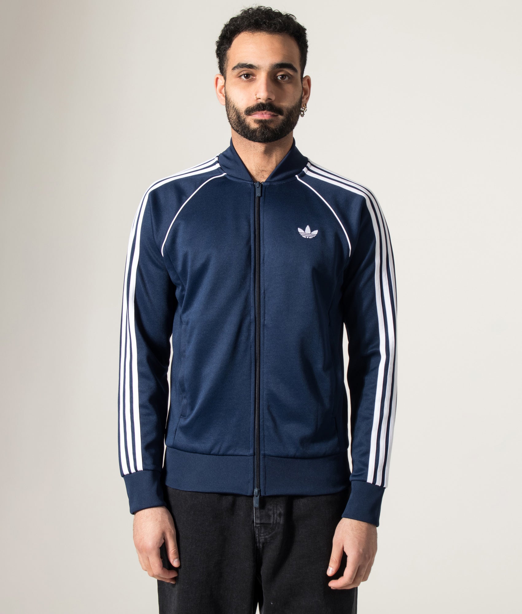 adidas Originals SST Track Top in Night Indigo at EQVVS Menswear. Model front shot.