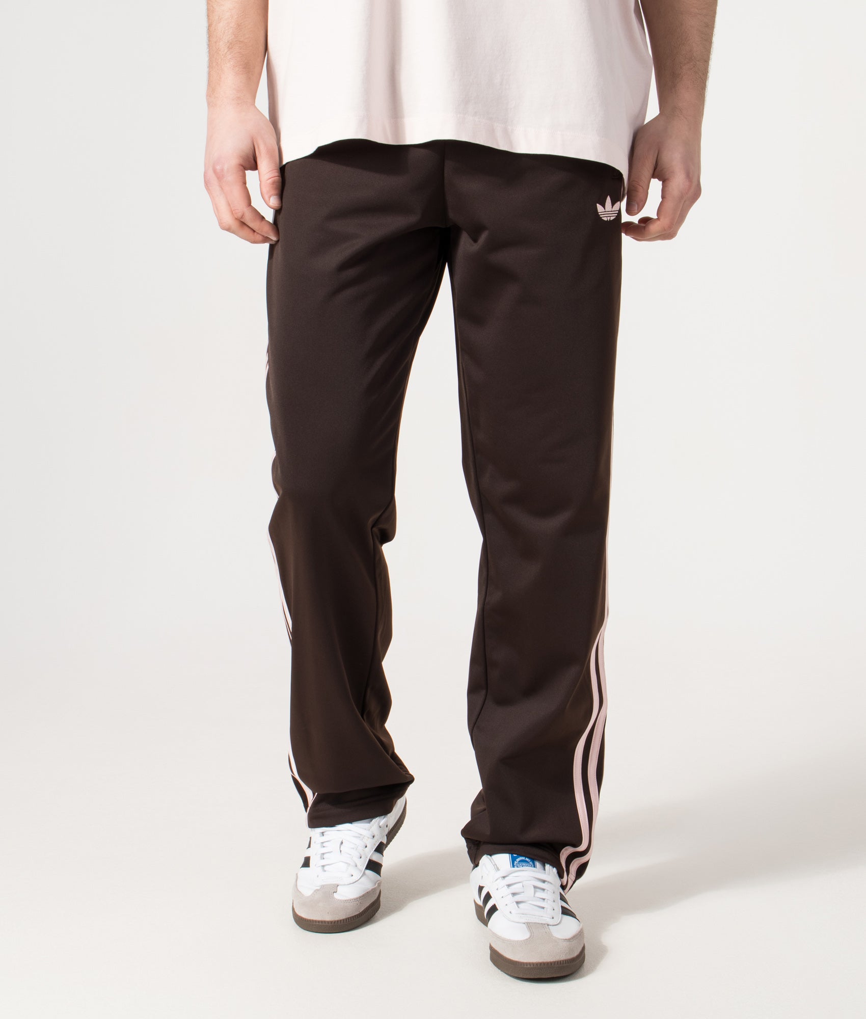 adidas Originals Firebird Track Pants in Aurora Coffee at EQVVS Menswear. Model front shot.