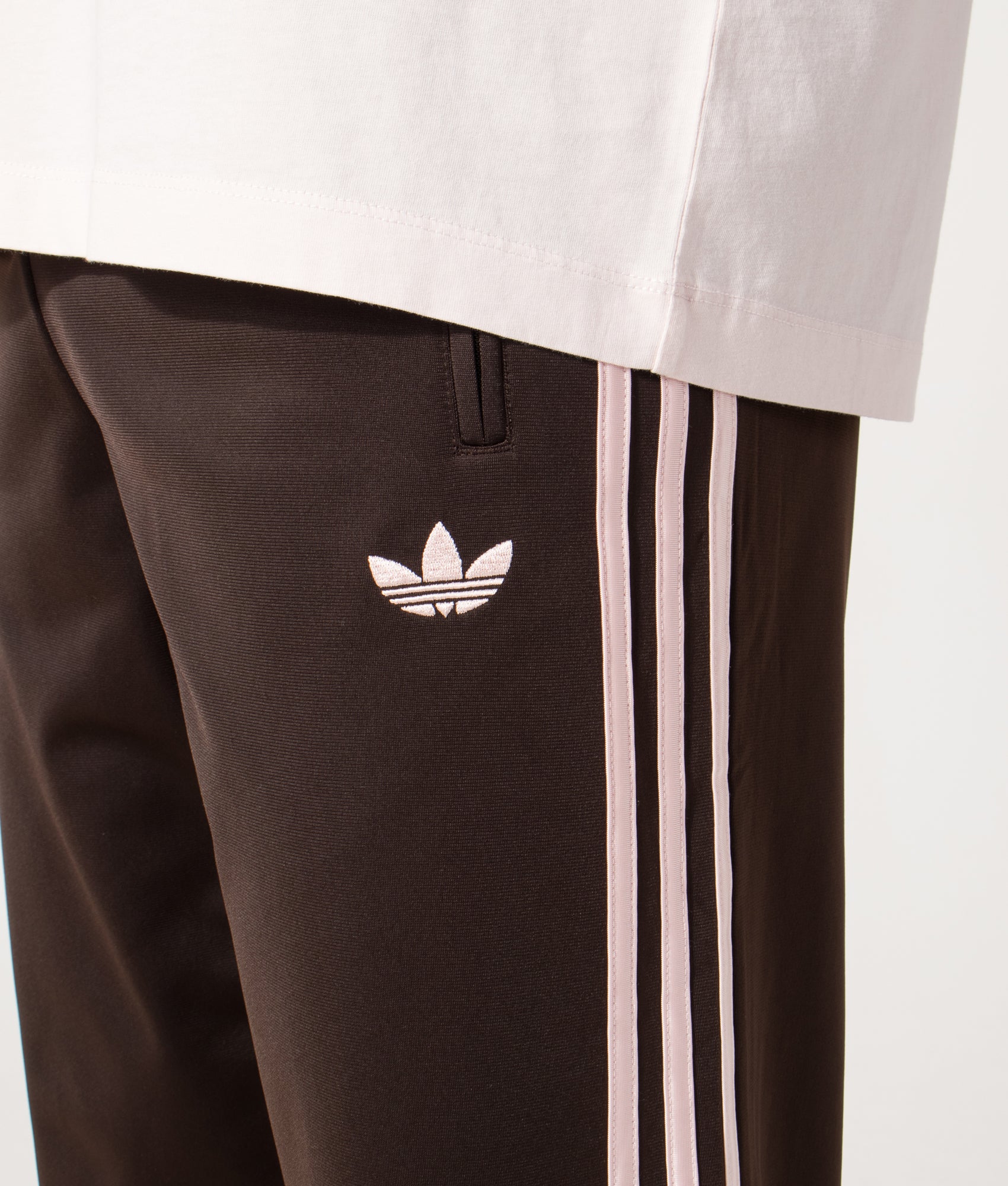 adidas Originals Firebird Track Pants in Aurora Coffee at EQVVS Menswear. Detail shot.
