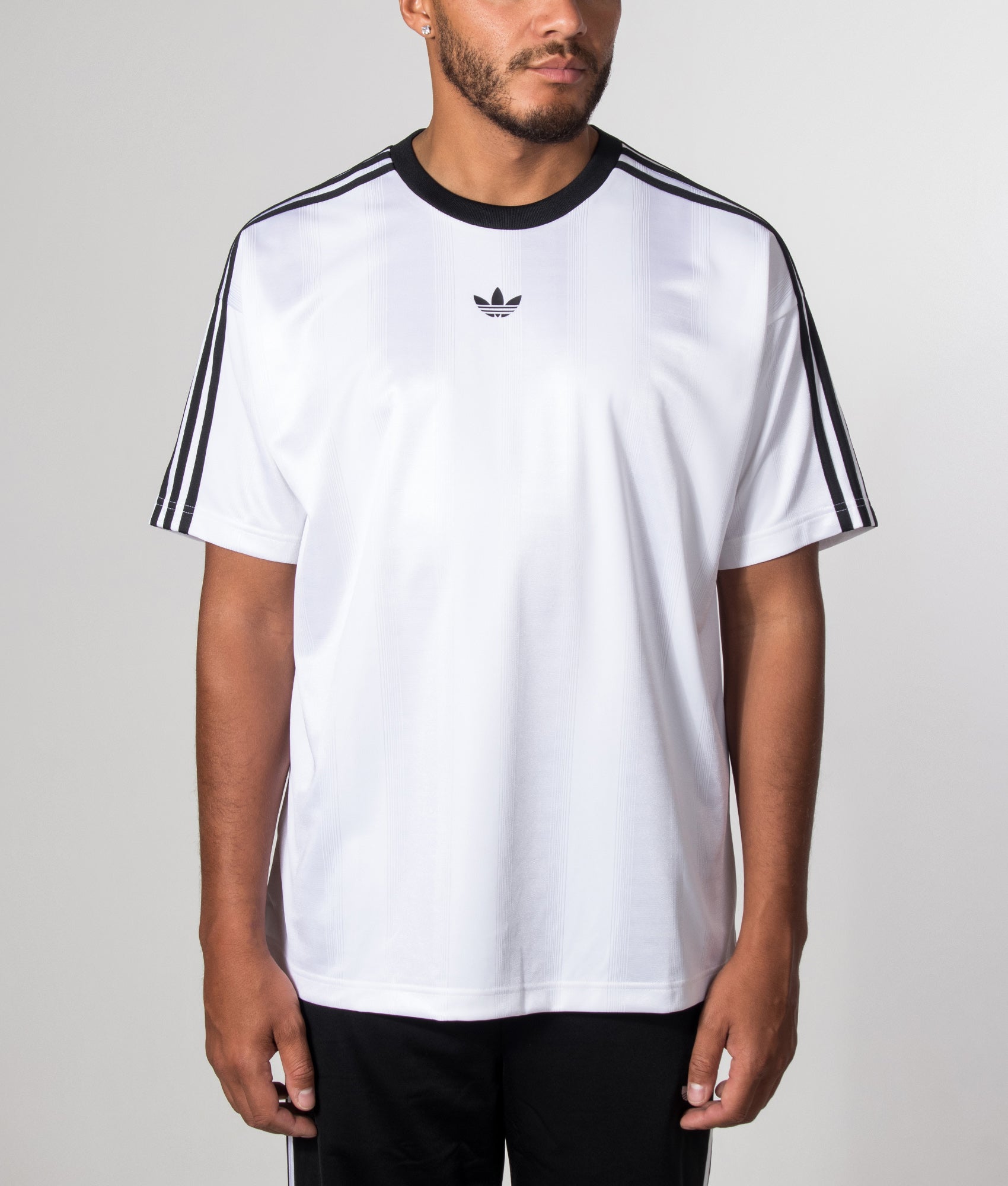 adidas Originals release the Oversized Fit Adicolour Jacquard Jersey T-Shirt in White at EQVVS Menswear. Model front shot.