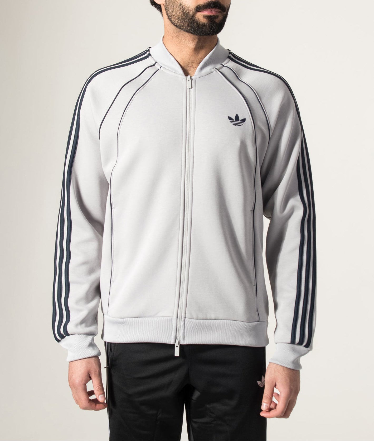 adidas Originals SST 2.0 Track Top in Grey Two at EQVVS Menswear. Model front shot.