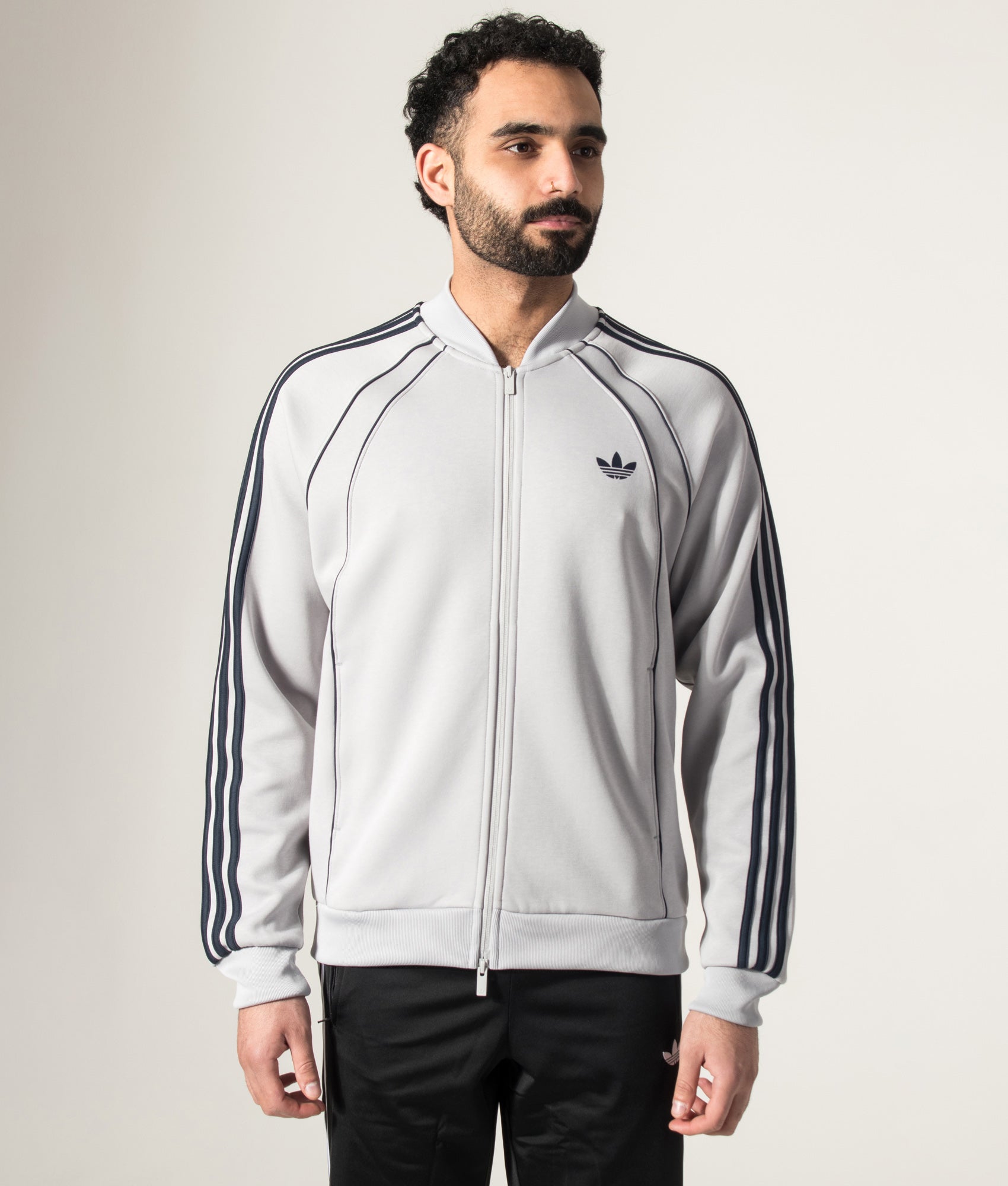 adidas Originals SST 2.0 Track Top in Grey Two at EQVVS Menswear. Model front shot.