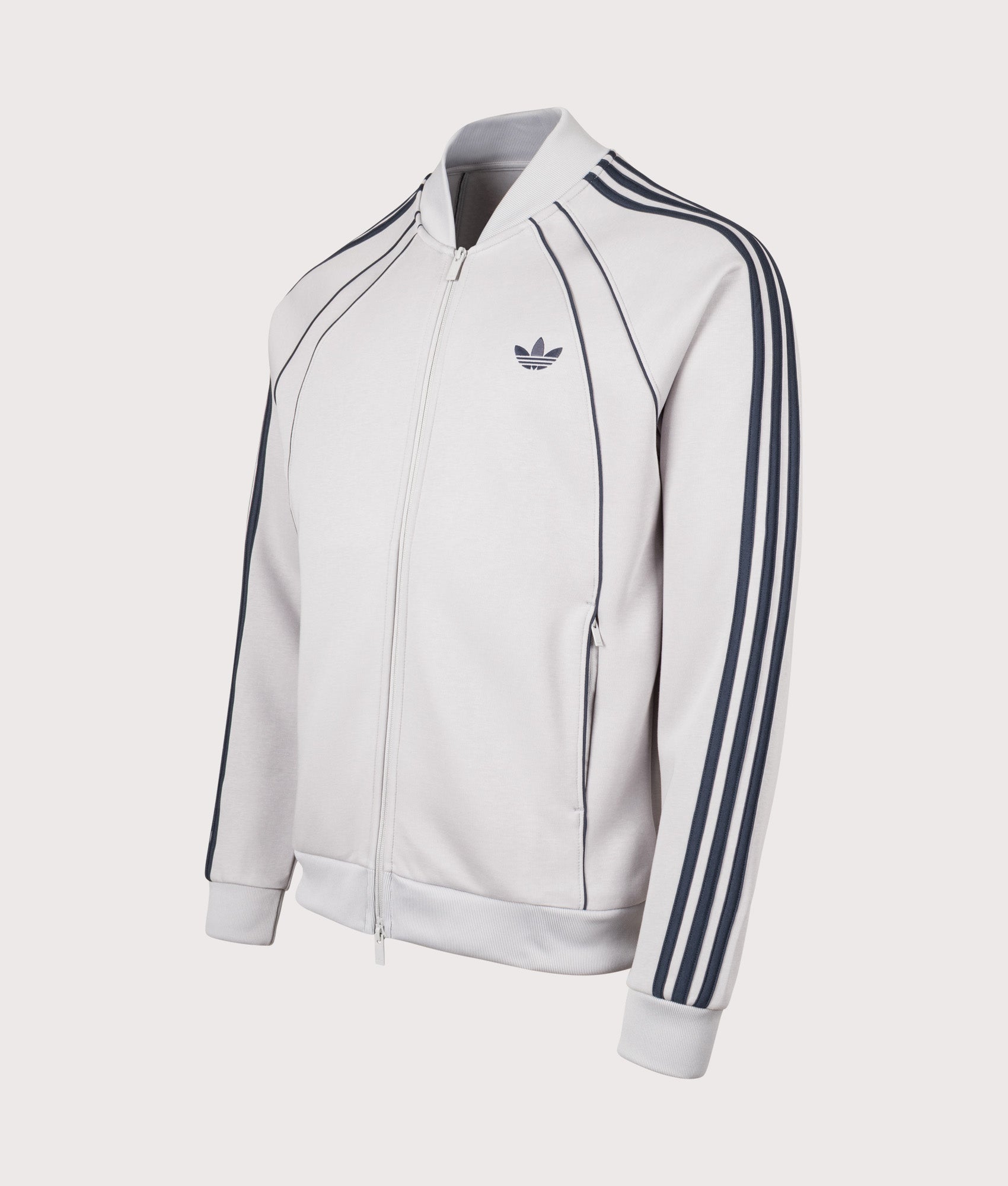 adidas Originals SST 2.0 Track Top in Grey Two at EQVVS Menswear. Angled front shot.
