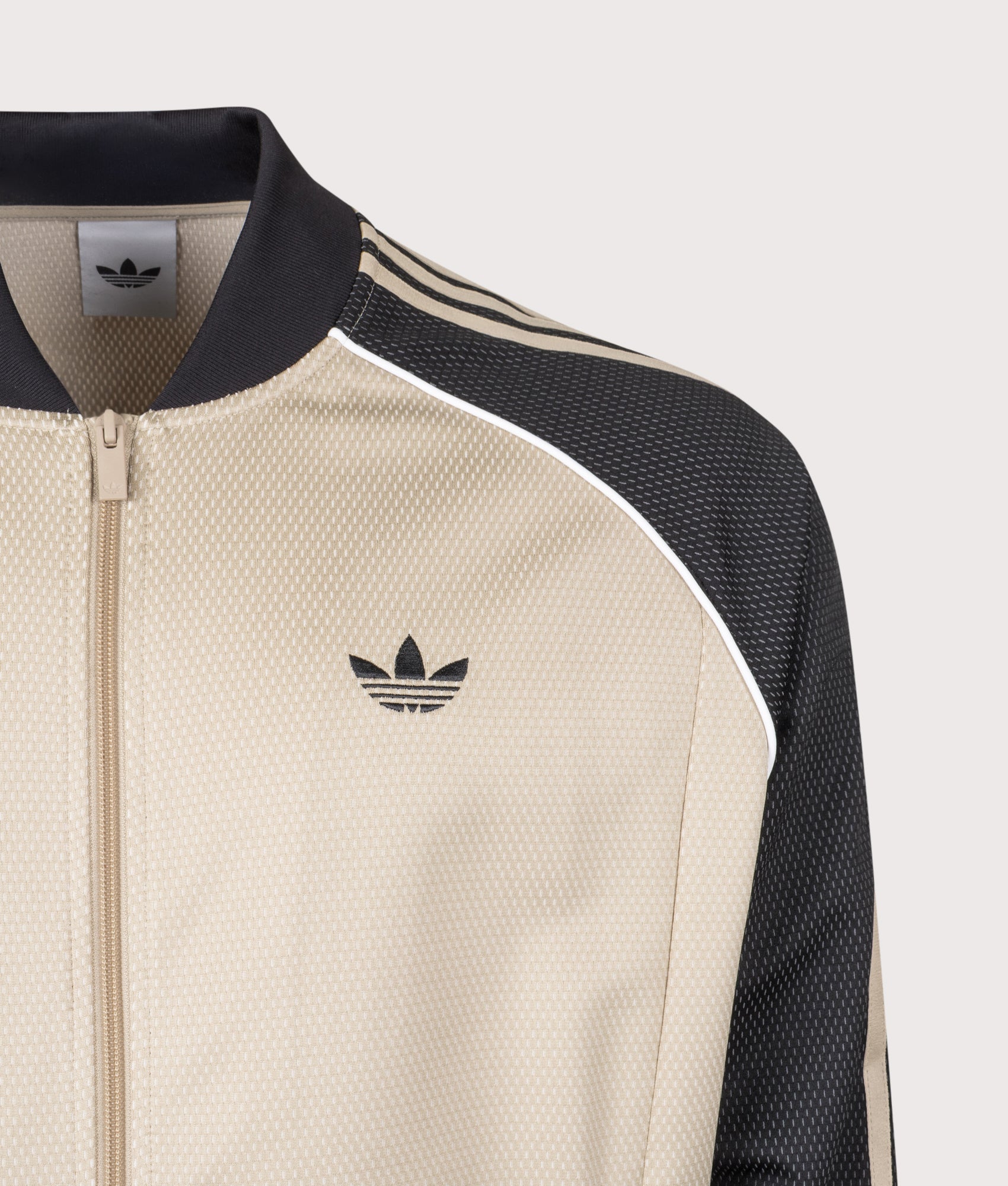 adidas Originals SST Track Top in Stone Khaki at EQVVS Menswear. Detail shot.