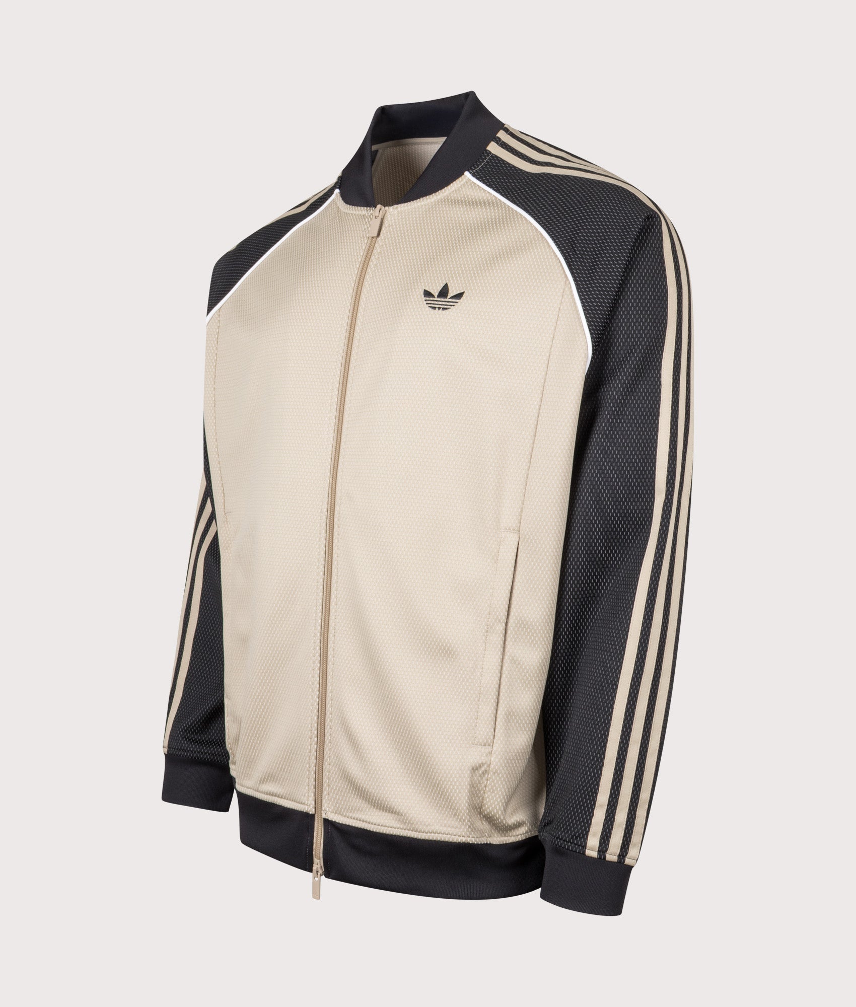 adidas Originals SST Track Top in Stone Khaki at EQVVS Menswear. Angled front shot.