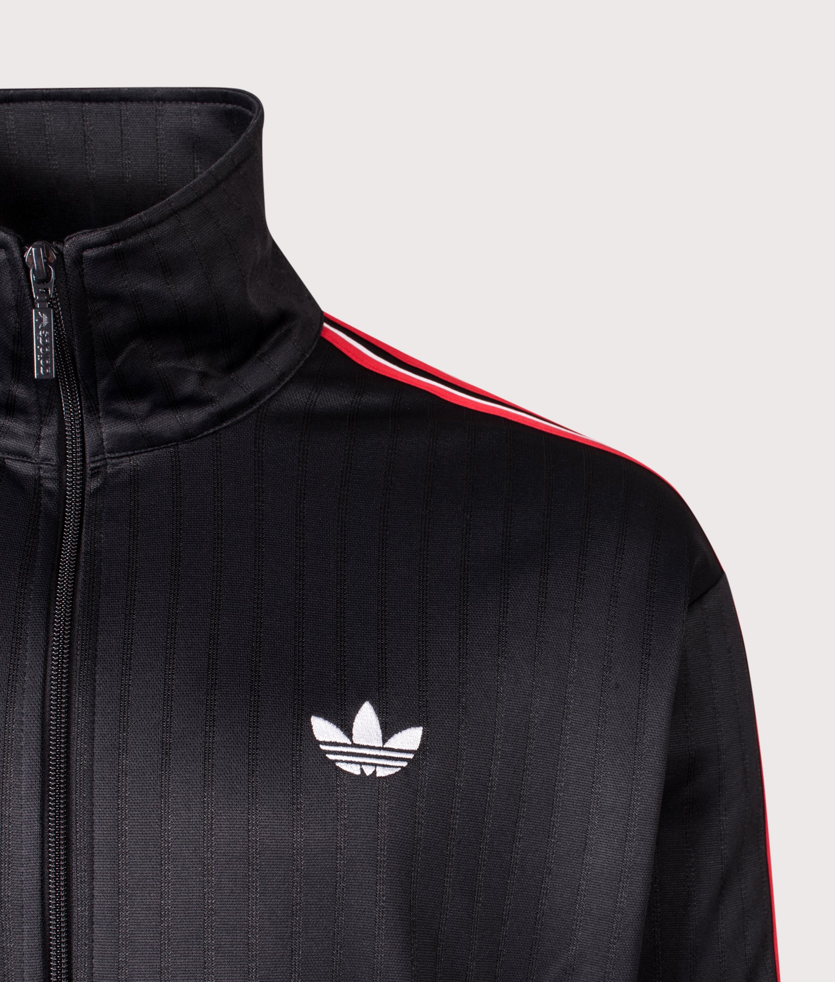adidas Originals Firebird Pinstripe Track Top in Black at EQVVS Menswear. Detail shot.