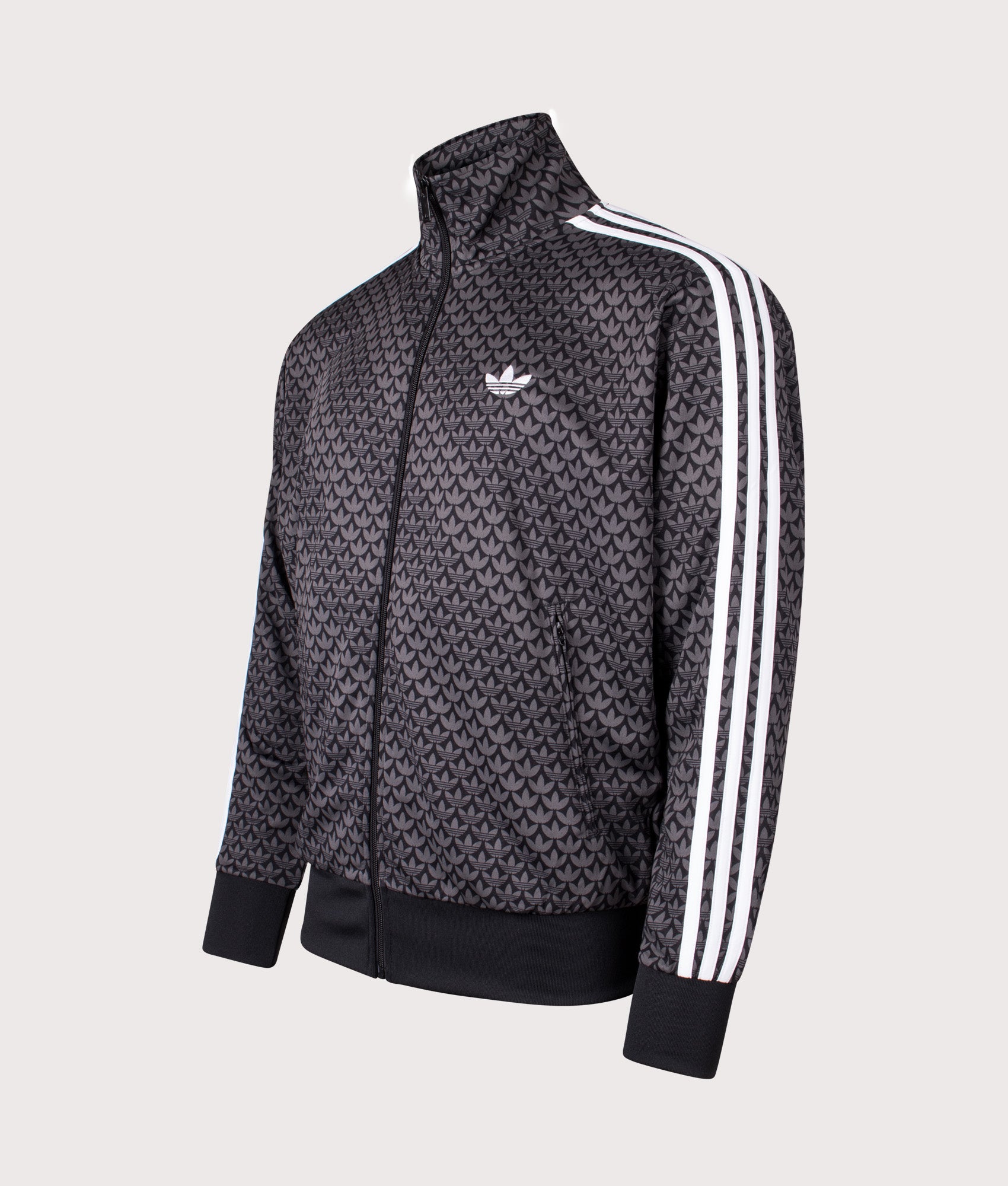 adidas Originals Firebird Monogram Track Top in Black at EQVVS Menswear. Angled front shot.