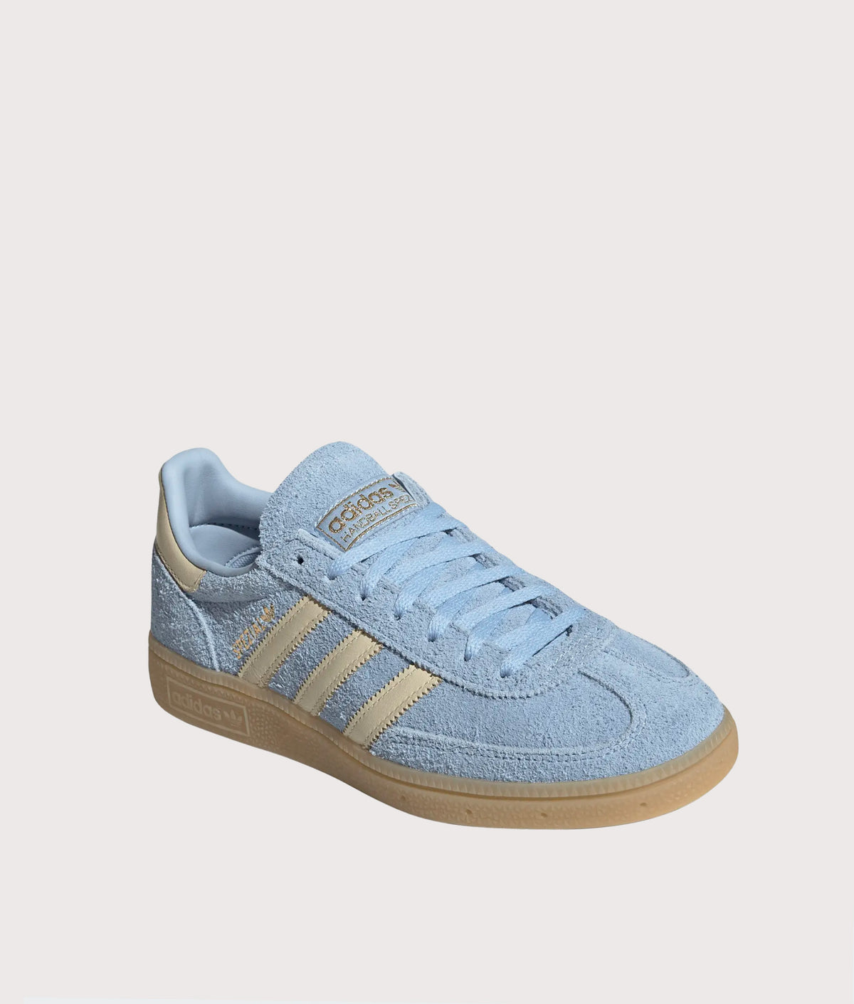 adidas Originals Handball Spezial Trainers in Clear Sky, Warm Vanilla and Gold Metallic at EQVVS Menswear. Angled front shot.