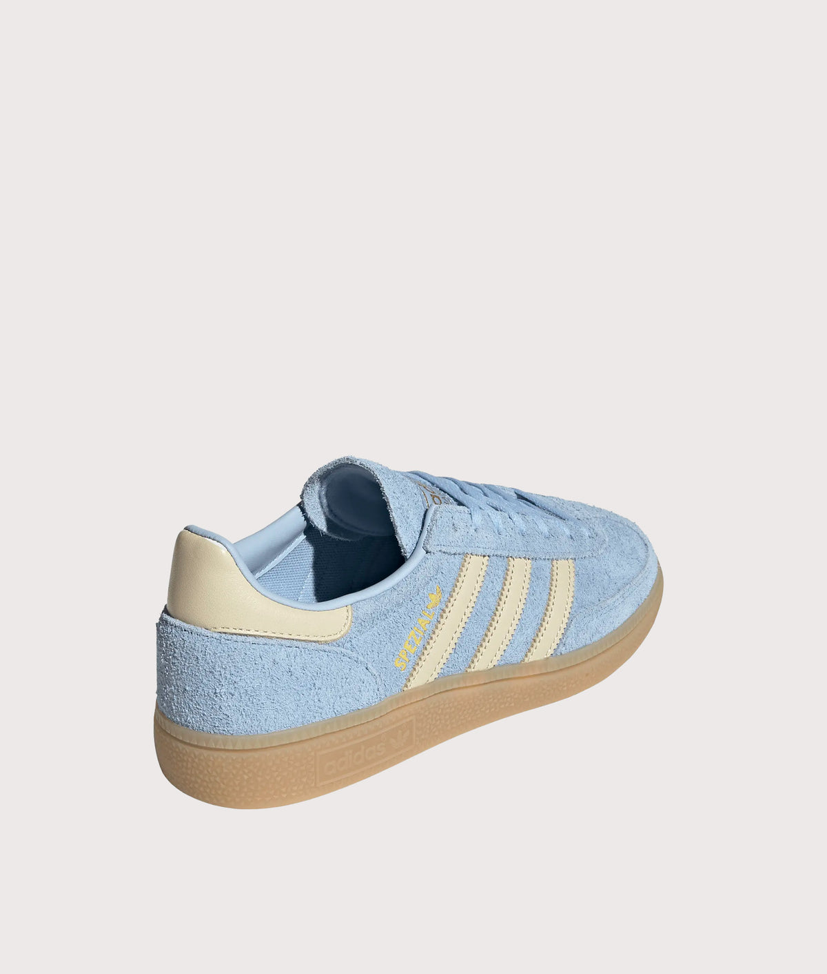 adidas Originals Handball Spezial Trainers in Clear Sky, Warm Vanilla and Gold Metallic at EQVVS Menswear. Angled back shot.