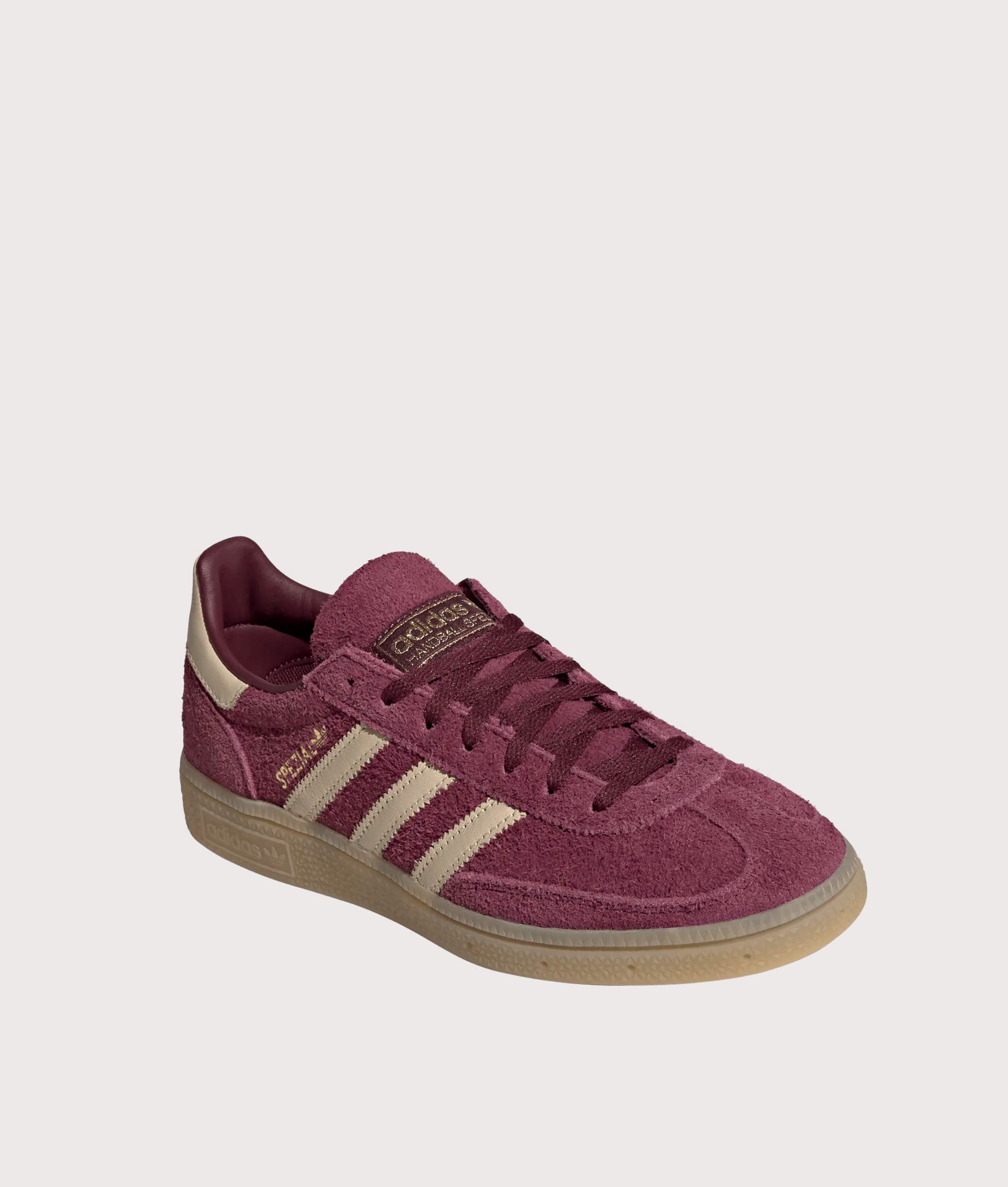 adidas Originals Handball Spezial Trainers in Maroon, Warm Vanilla and Gold Metallic at EQVVS Menswear. Angled front shot.