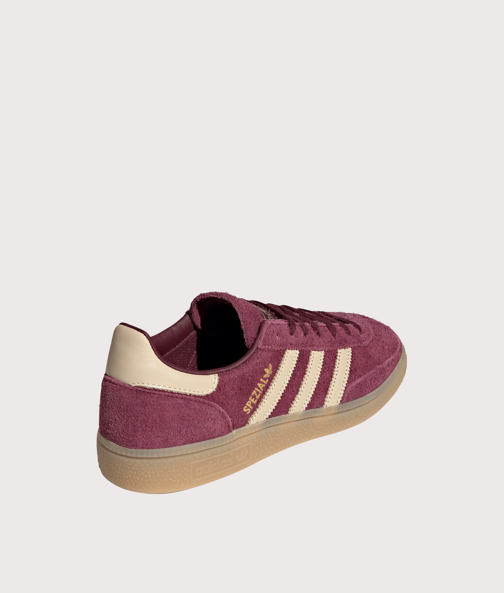 adidas Originals Handball Spezial Trainers in Maroon, Warm Vanilla and Gold Metallic at EQVVS Menswear. Angled back shot.