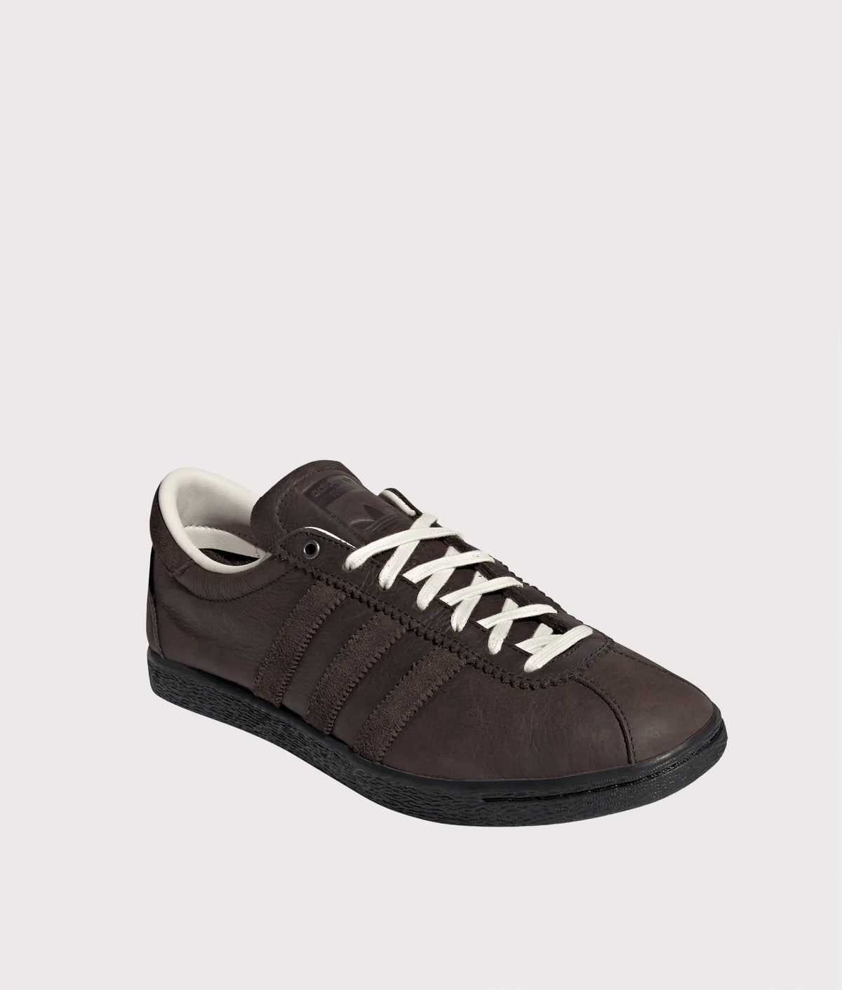 adidas Original Tobacco Trainers in Dark Brown, Aurora Coffee and Core Black at EQVVS Menswear. Angled front shot.