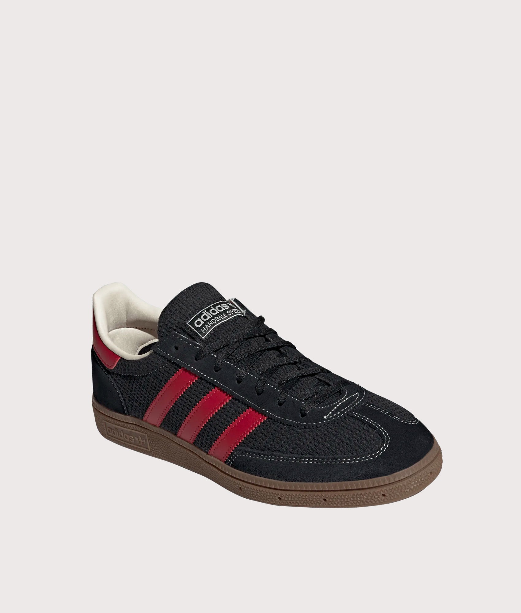 adidas Originals Handball Spezial Trainers in Core Black, Team Victory Red and Gum5 at EQVVS Menswear. Angled front shot.