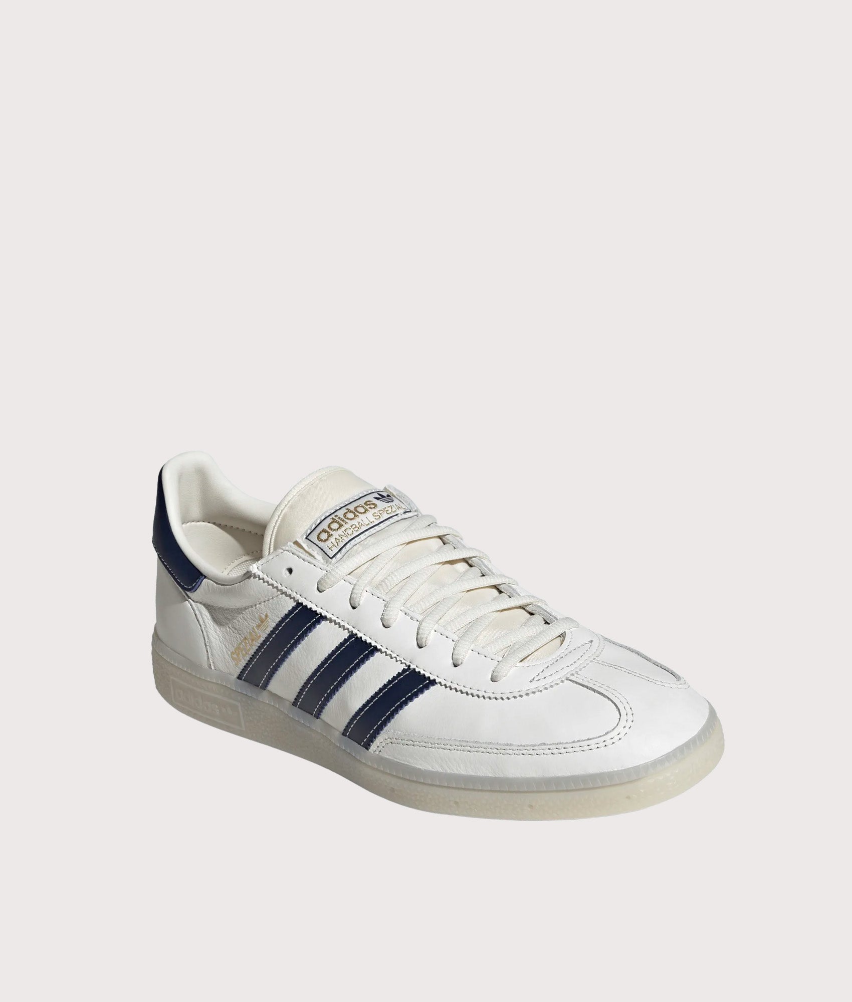 adidas Originals Handball Spezial Trainers in Core White, Night Indigo and Off White at EQVVS Menswear. Angled front shot.