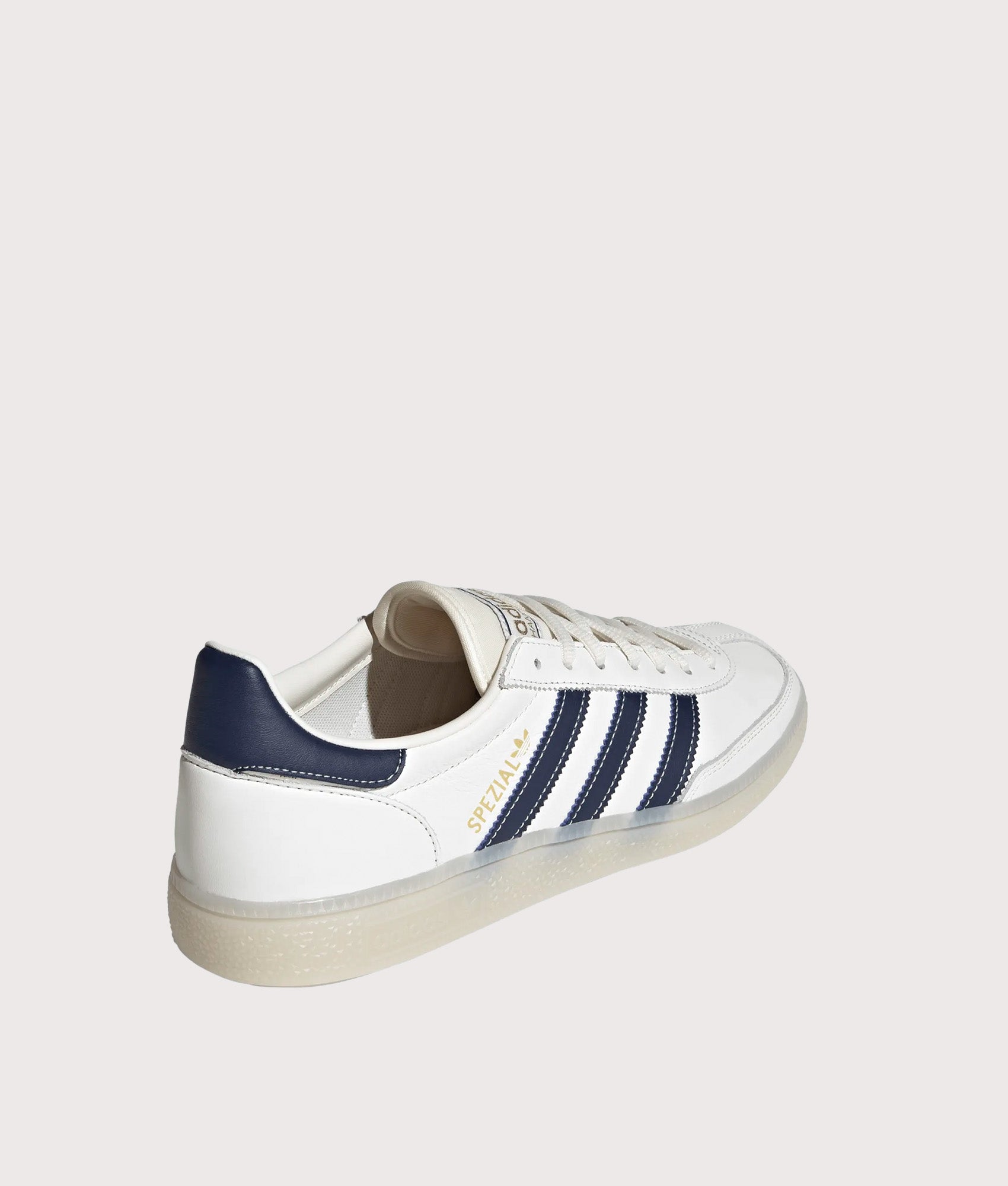 adidas Originals Handball Spezial Trainers in Core White, Night Indigo and Off White at EQVVS Menswear. Angled back shot.