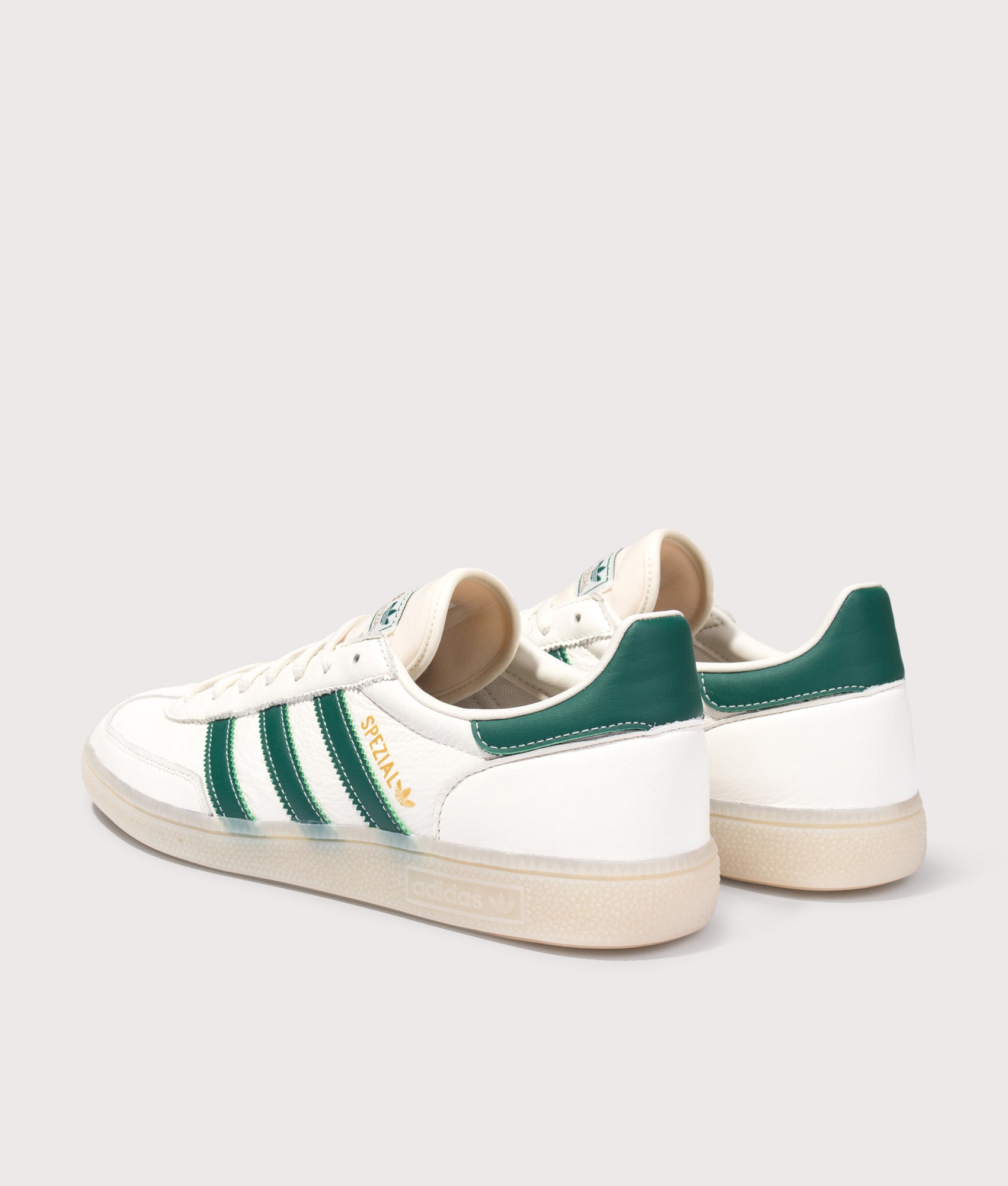 adidas Originals Handball Spezial Trainers in Core White, Collegiate Green and Off White at EQVVS Menswear. Angled back shot.