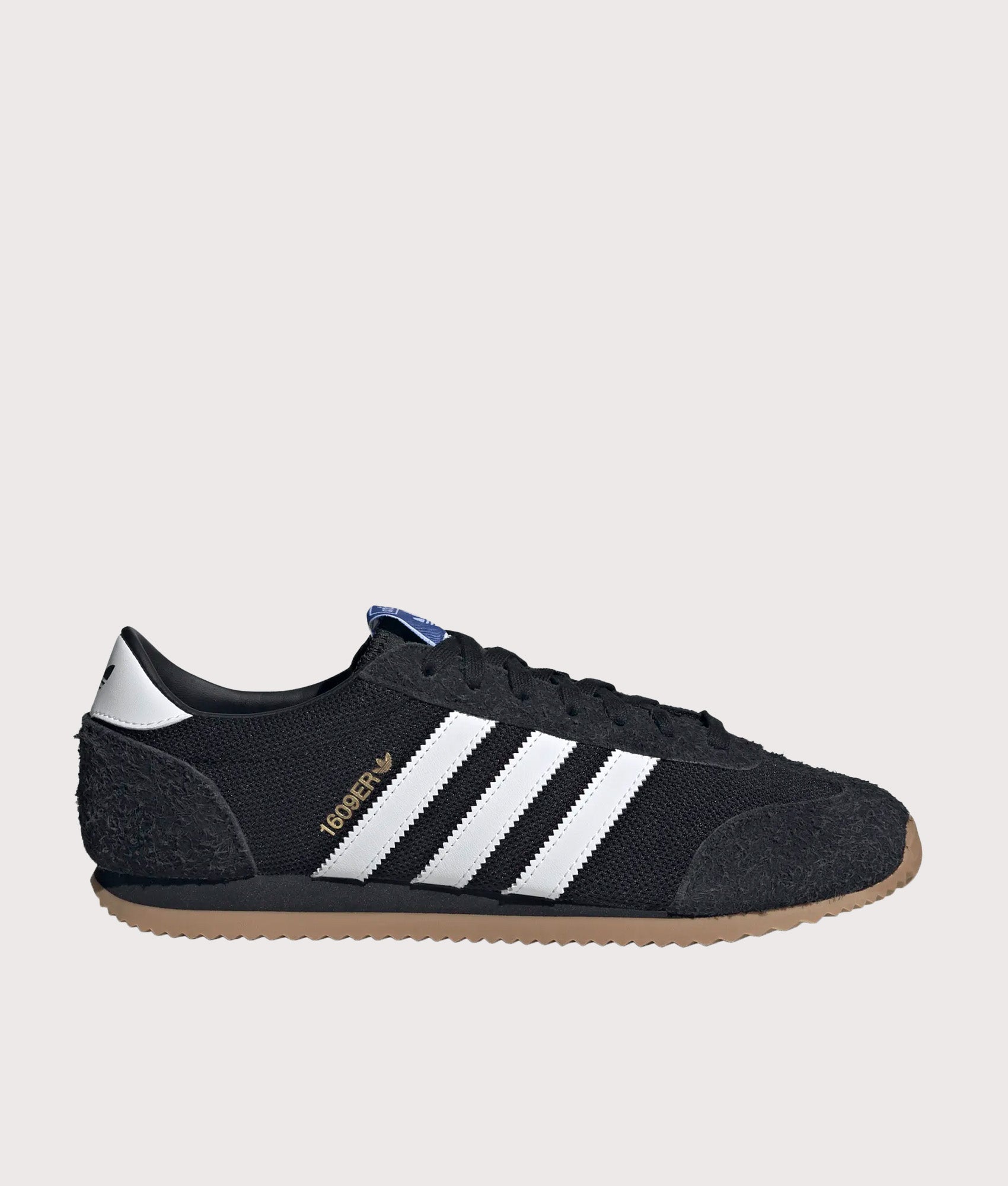 adidas Originals 1609ER RS Trainers in Core Black, Footwear White and Gold Metallic at EQVVS Menswear. Side shot.