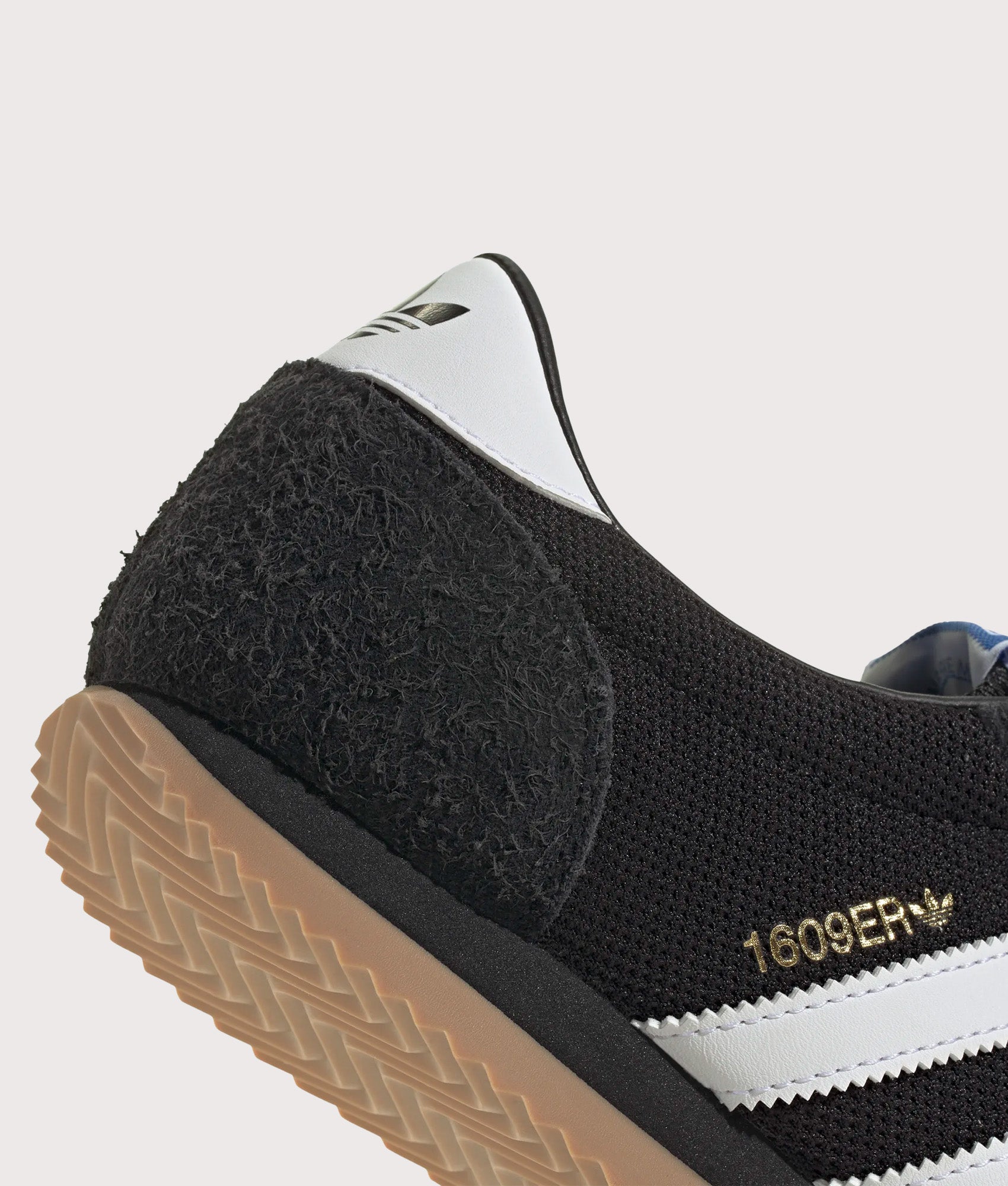 adidas Originals 1609ER RS Trainers in Core Black, Footwear White and Gold Metallic at EQVVS Menswear. Detail shot.