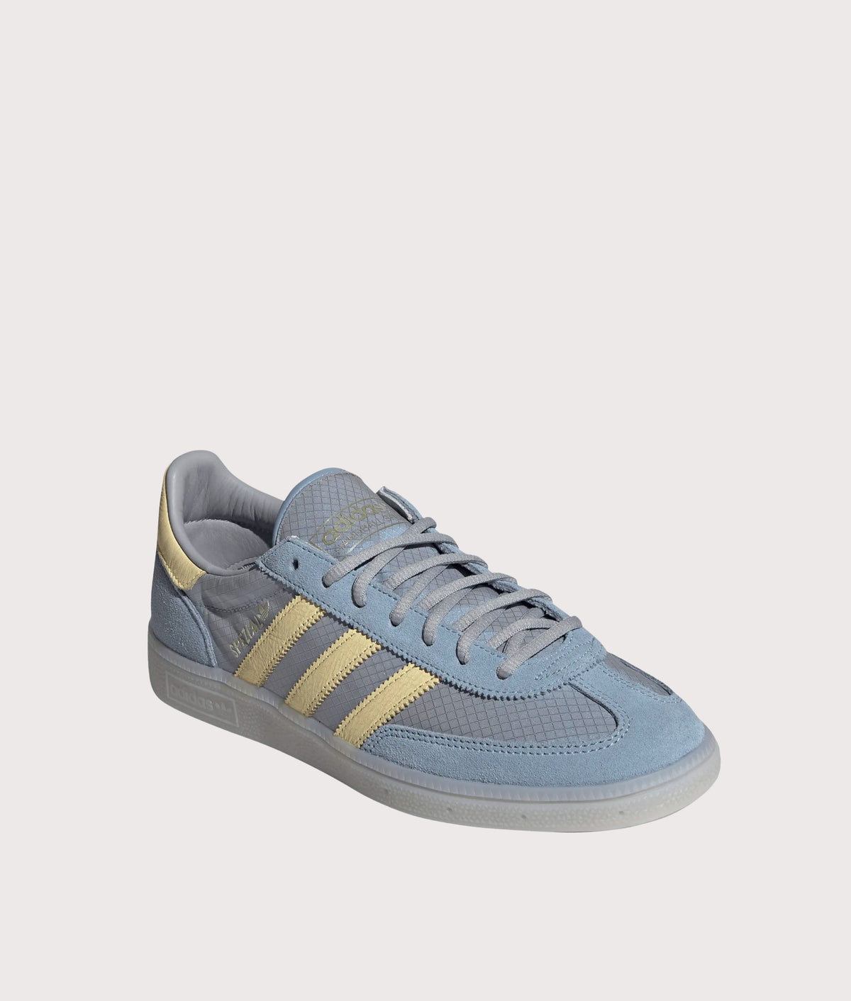 adidas Originals Handball Spezial Trainers  in Ambient Sky, Almost Yellow and Clear Grey at EQVVS Menswear. Angled front shot.