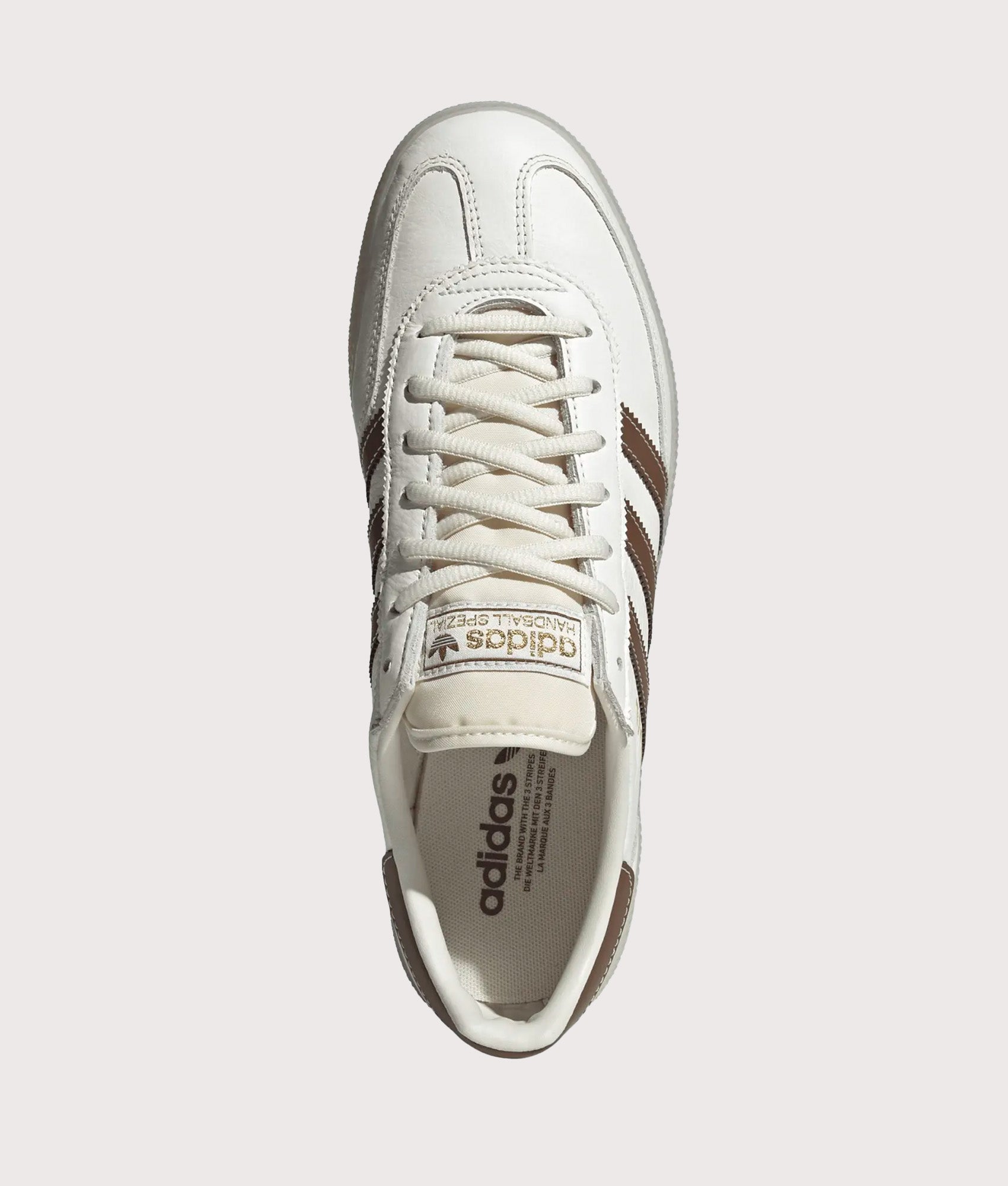 adidas Originals Handball Spezial Trainers in Core White, Preloved Brown and Off White at EQVVS Menswear. Top shot.