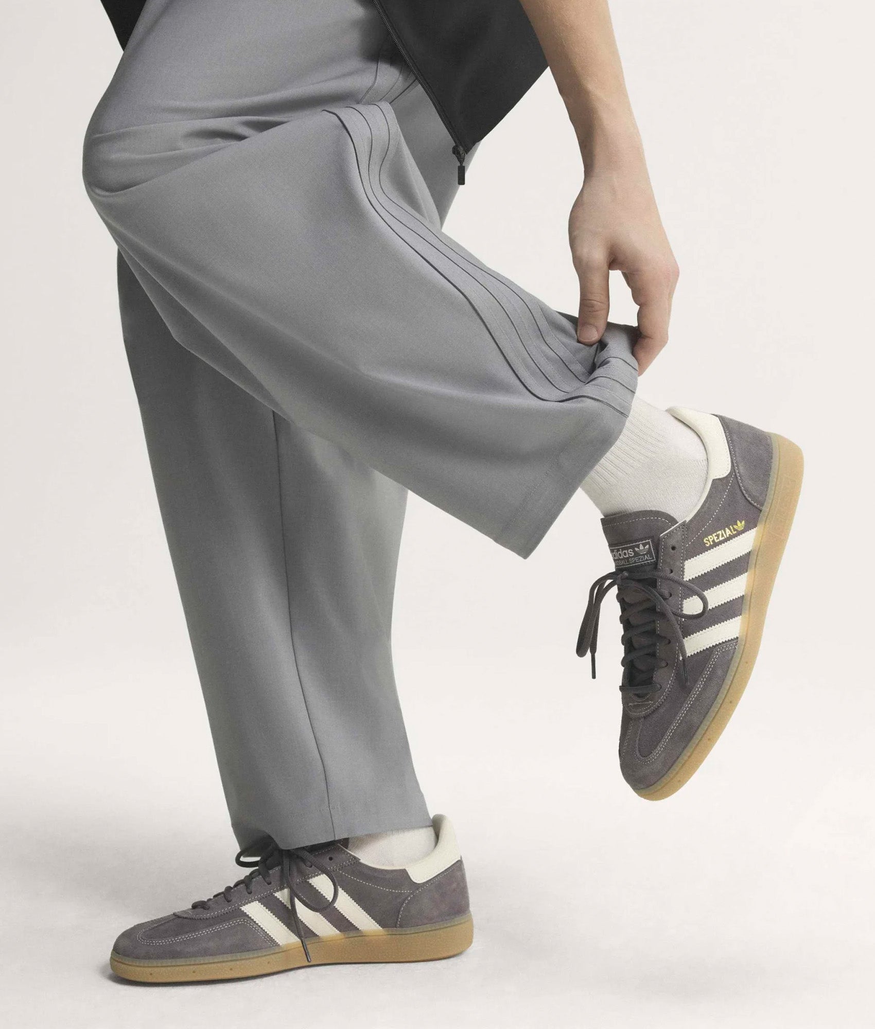 adidas Originals Handball Spezial Trainers in Grey Three, Off White and Gum 4 at EQVVS Menswear. Model front shot.
