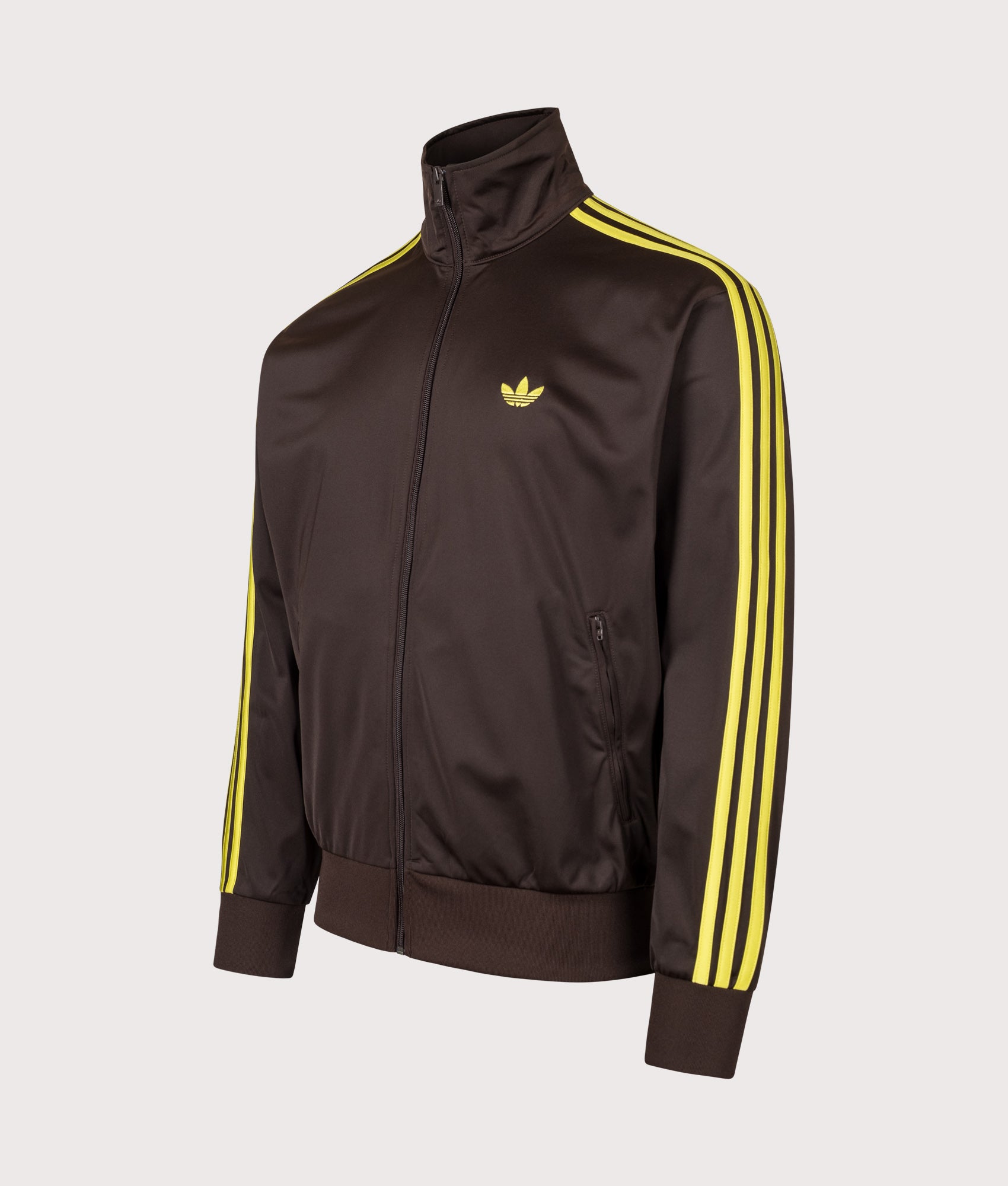 adidas Originals Loose Fit Firebird Track Top in Aurora Coffee and Preloved Lime at EQVVS Menswear. Angled front shot.
