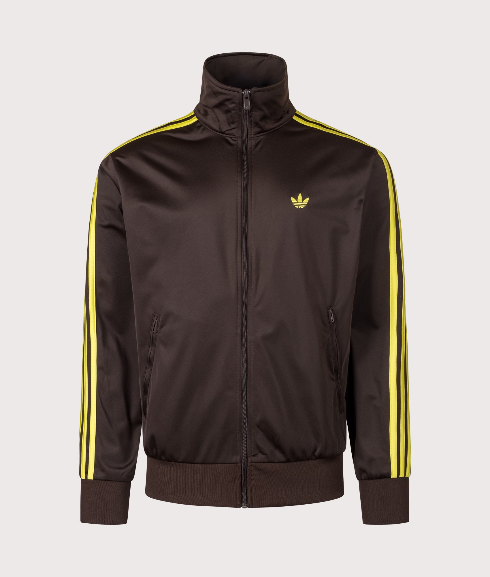 adidas Originals Loose Fit Firebird Track Top in Aurora Coffee and Preloved Lime at EQVVS Menswear. Front shot.