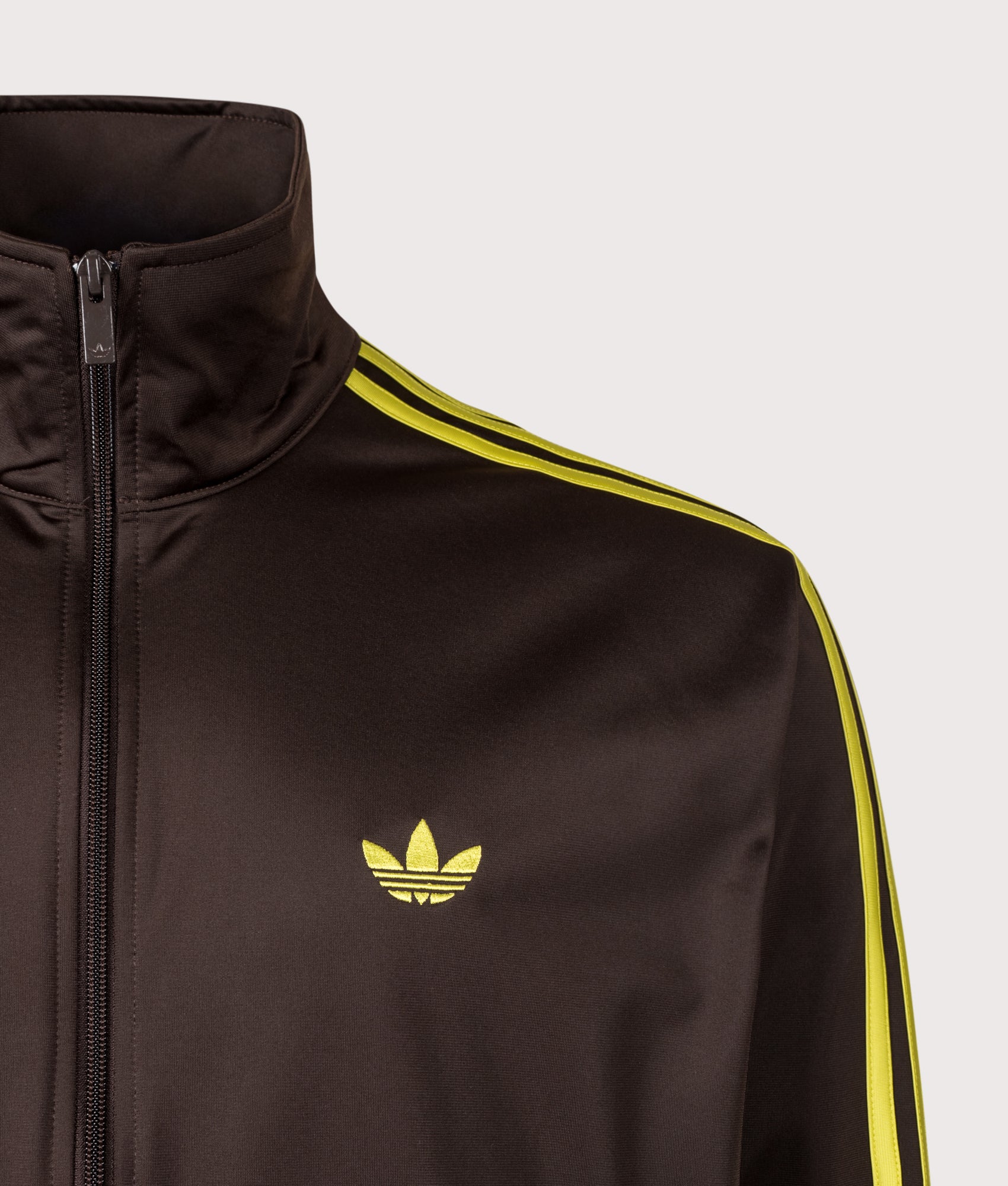 adidas Originals Loose Fit Firebird Track Top in Aurora Coffee and Preloved Lime at EQVVS Menswear. Detail shot.