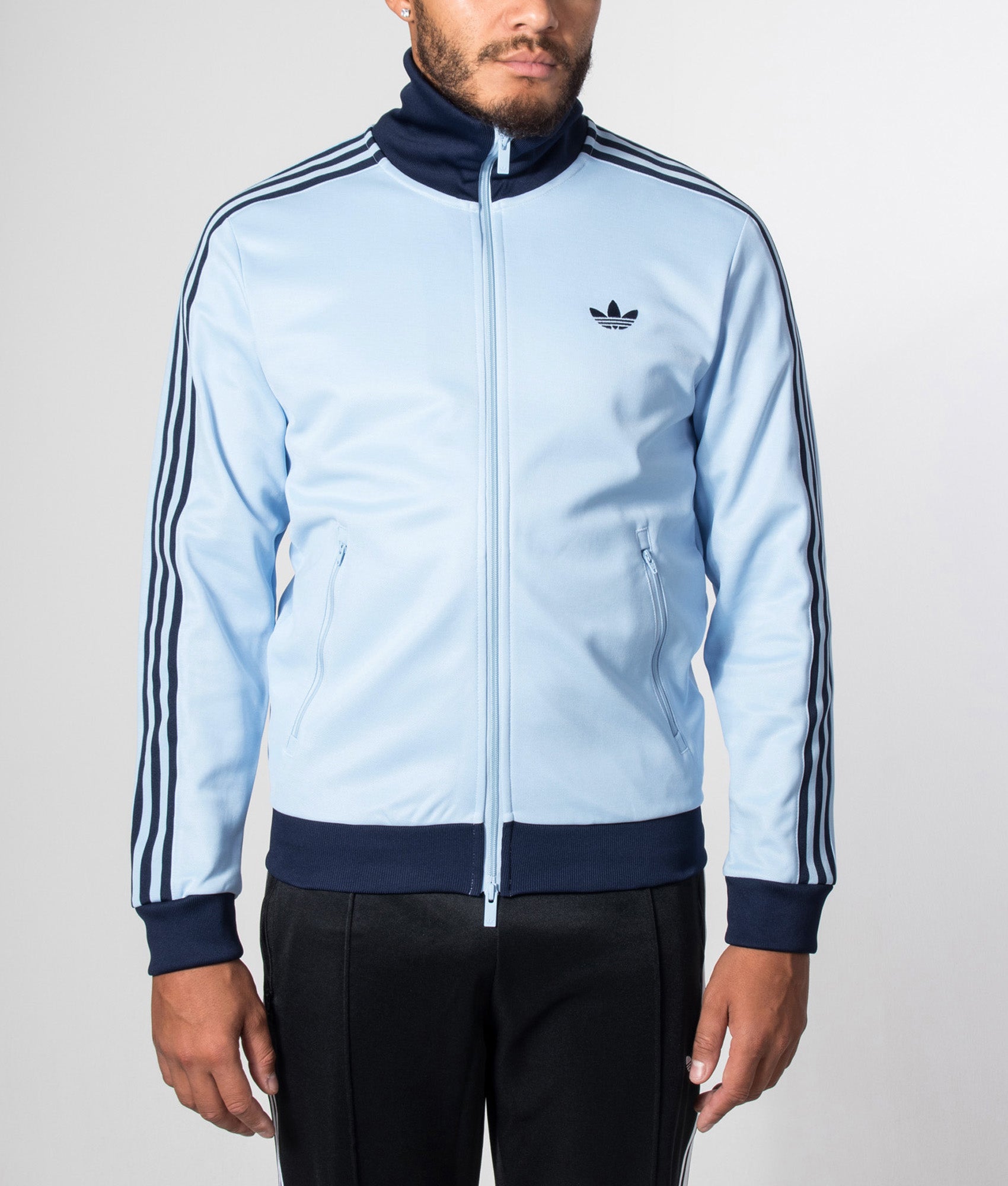 adidas Originals Beckenbauer Classic Track Top in Clear Sky and Night Indigo at EQVVS Menswear. Model front shot.