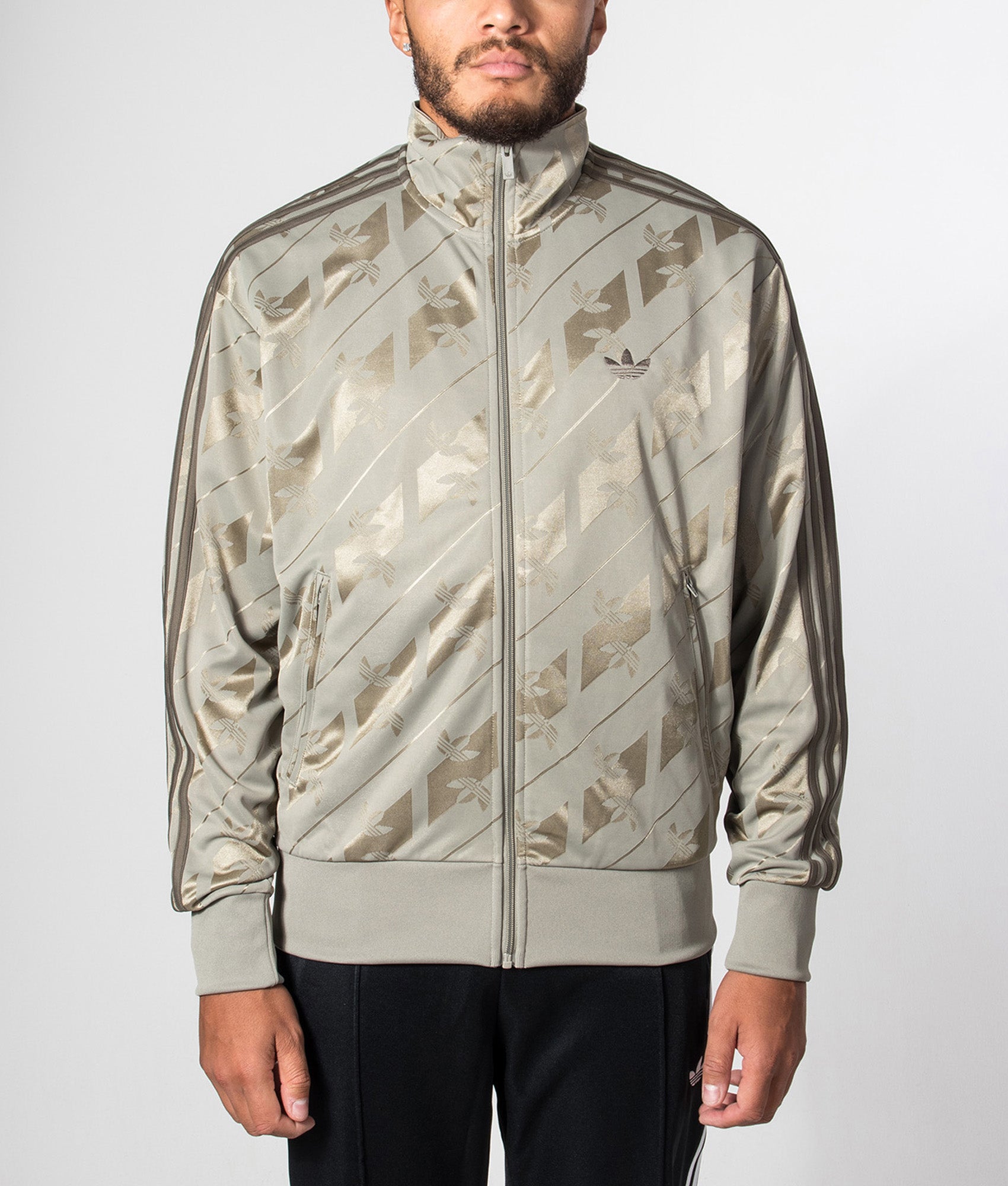 adidas Originals Loose Fit Firebird Monogram Track Top in Silver Pebble at EQVVS Menswear. Model front shot.