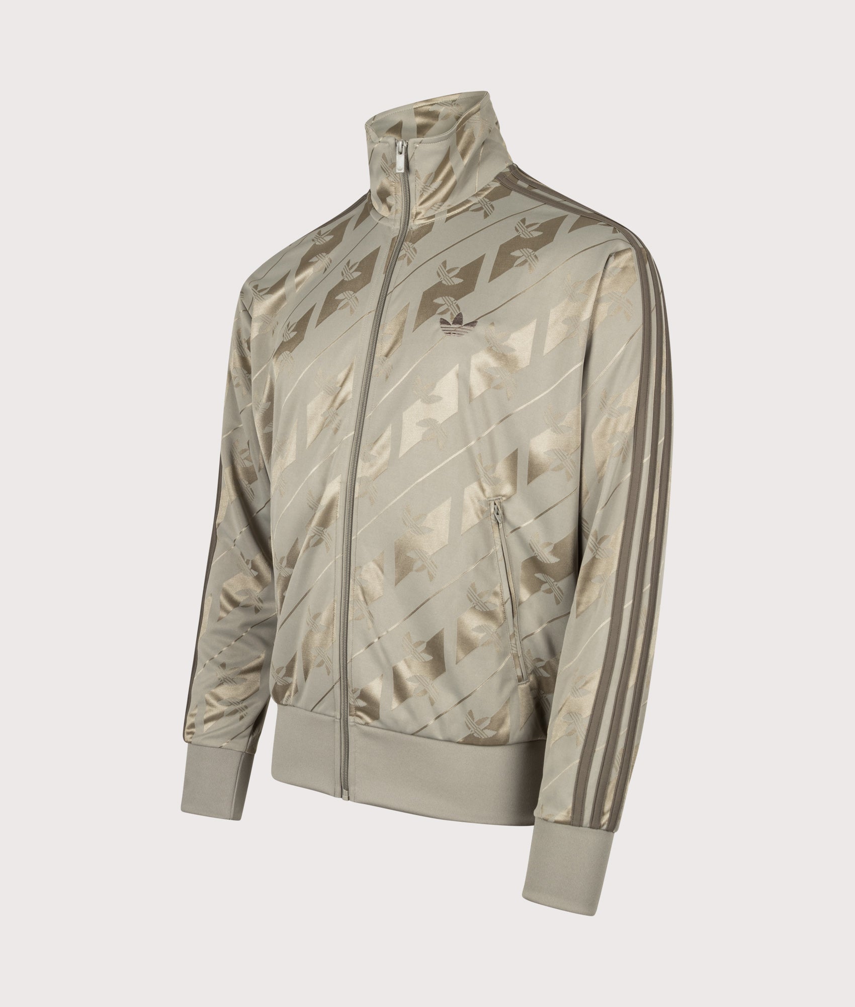 adidas Originals Loose Fit Firebird Monogram Track Top in Silver Pebble at EQVVS Menswear. Angled front shot.