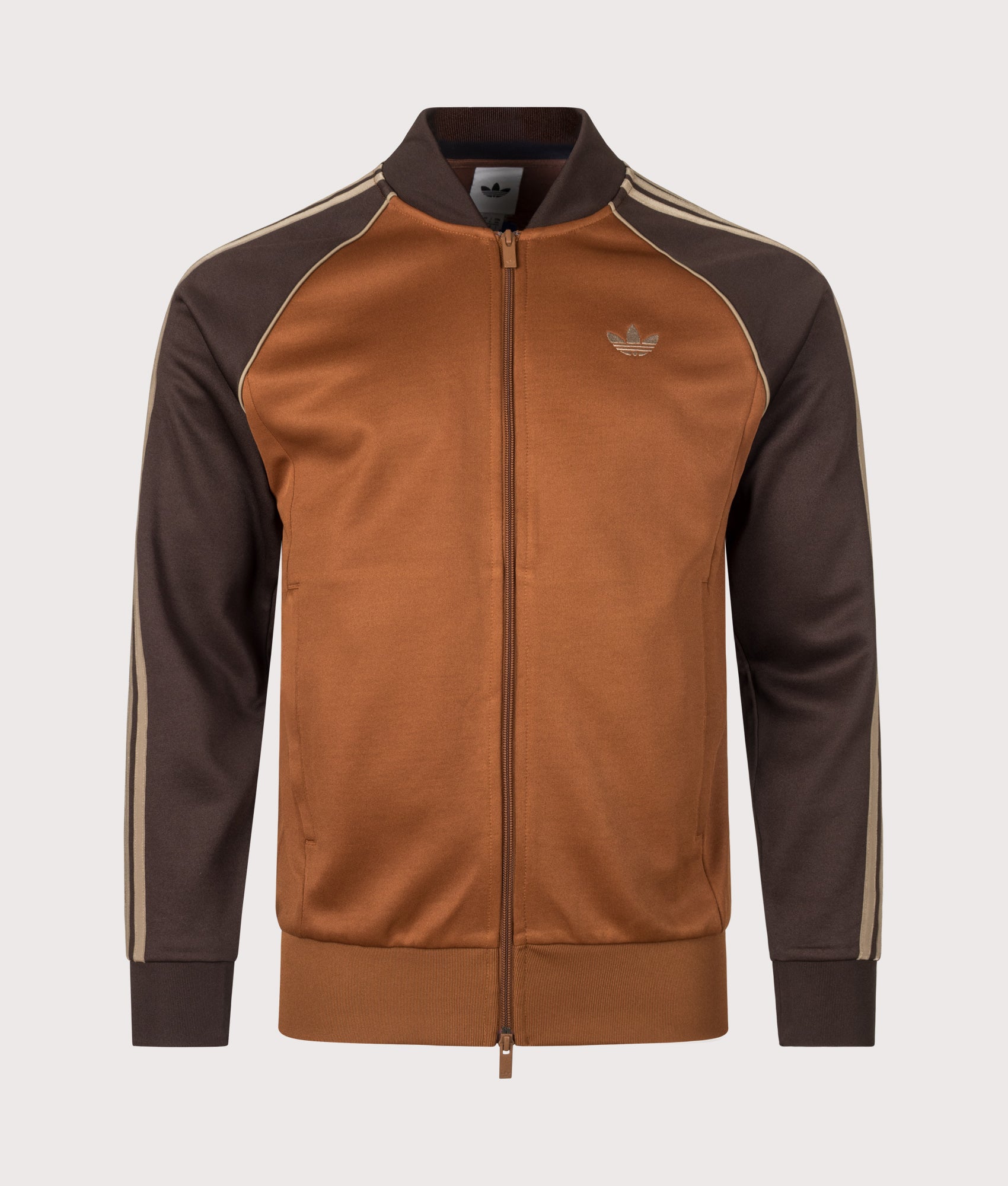 adidas Originals SST Track Top in Dust Brown at EQVVS Menswear. Front shot.