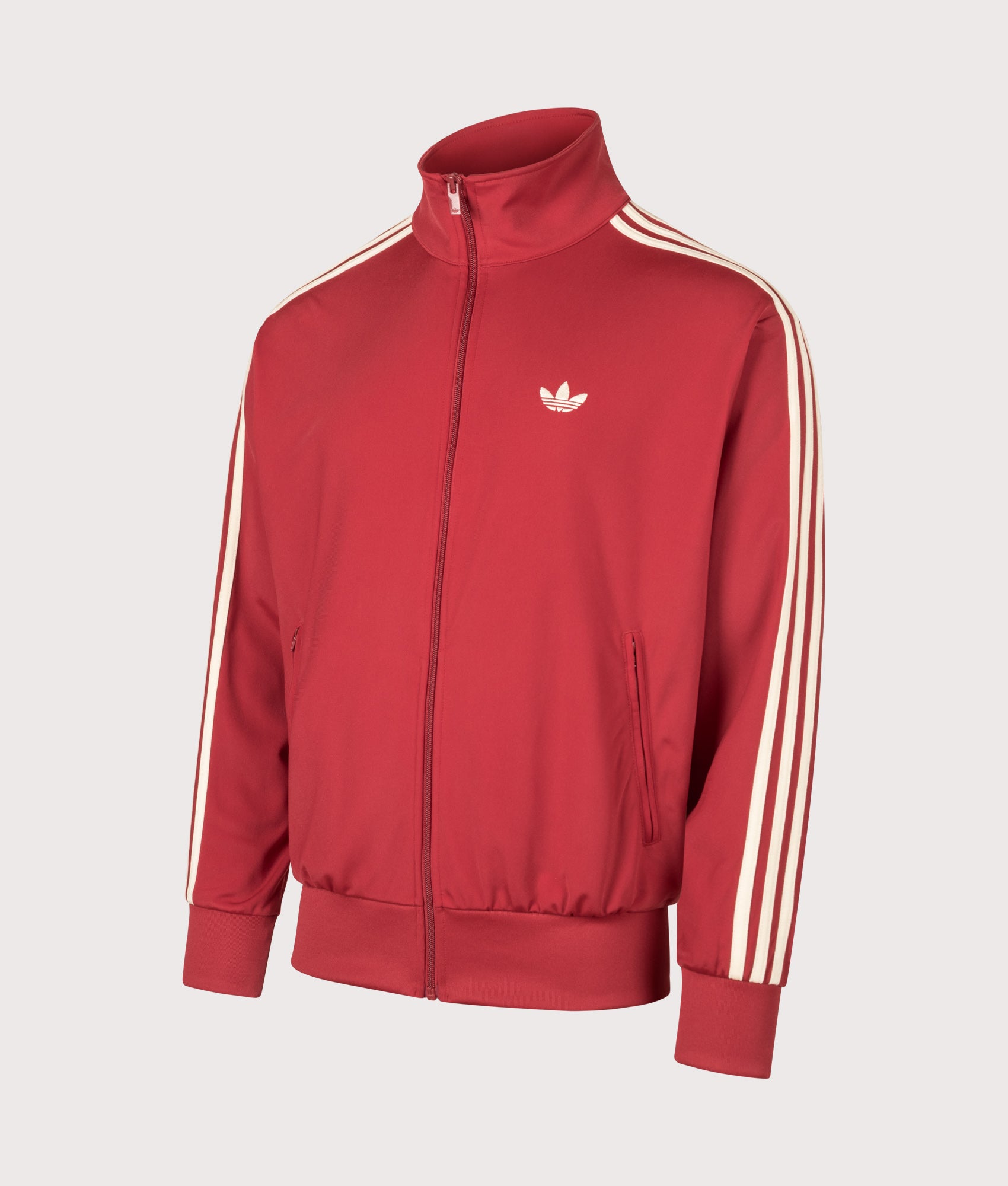adidas Originals Loose Fit Firebird Track Top in Team Victory Red and Warm Vanilla at EQVVS Menswear. Angled front shot.