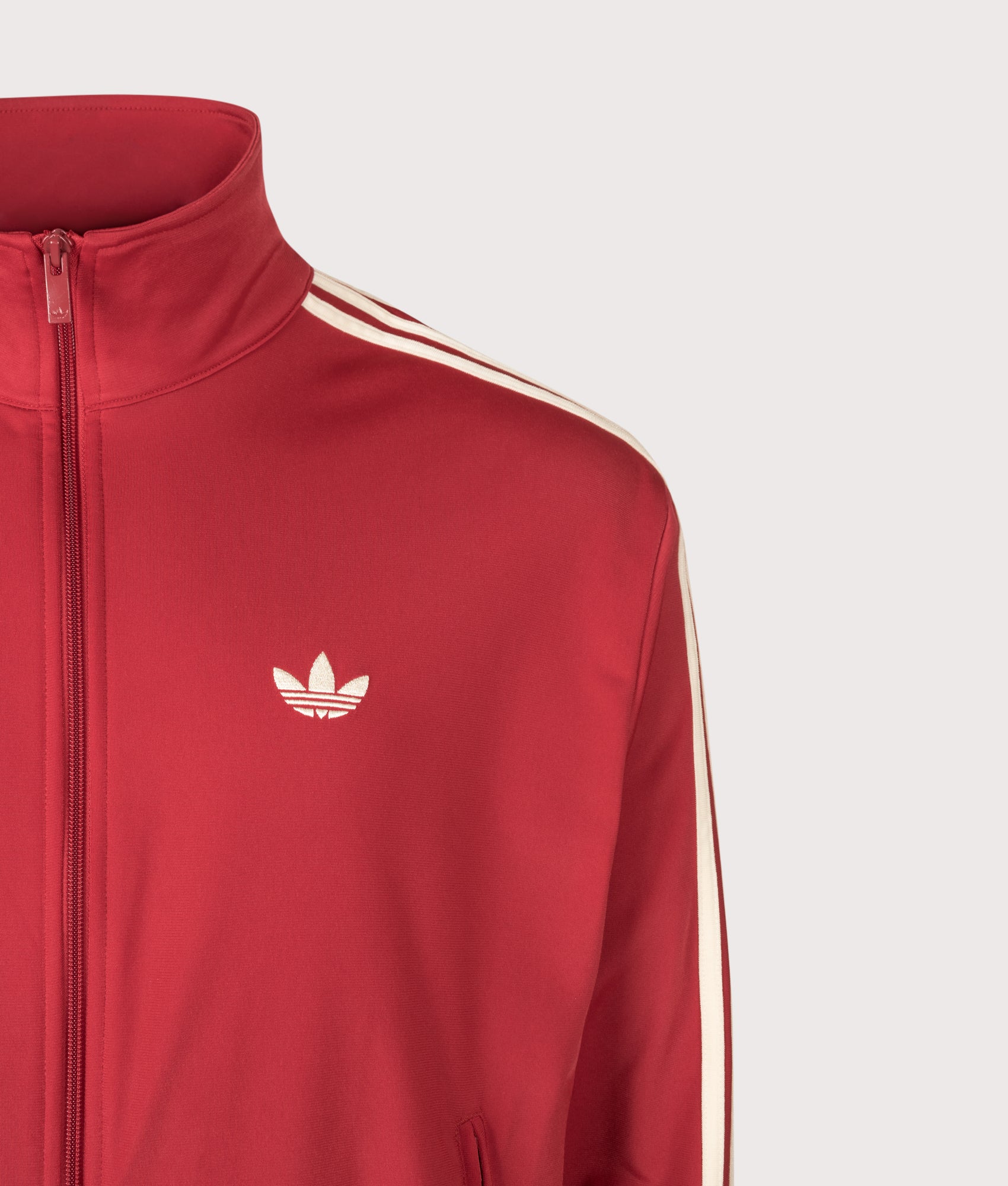adidas Originals Loose Fit Firebird Track Top in Team Victory Red and Warm Vanilla at EQVVS Menswear. Detail shot.