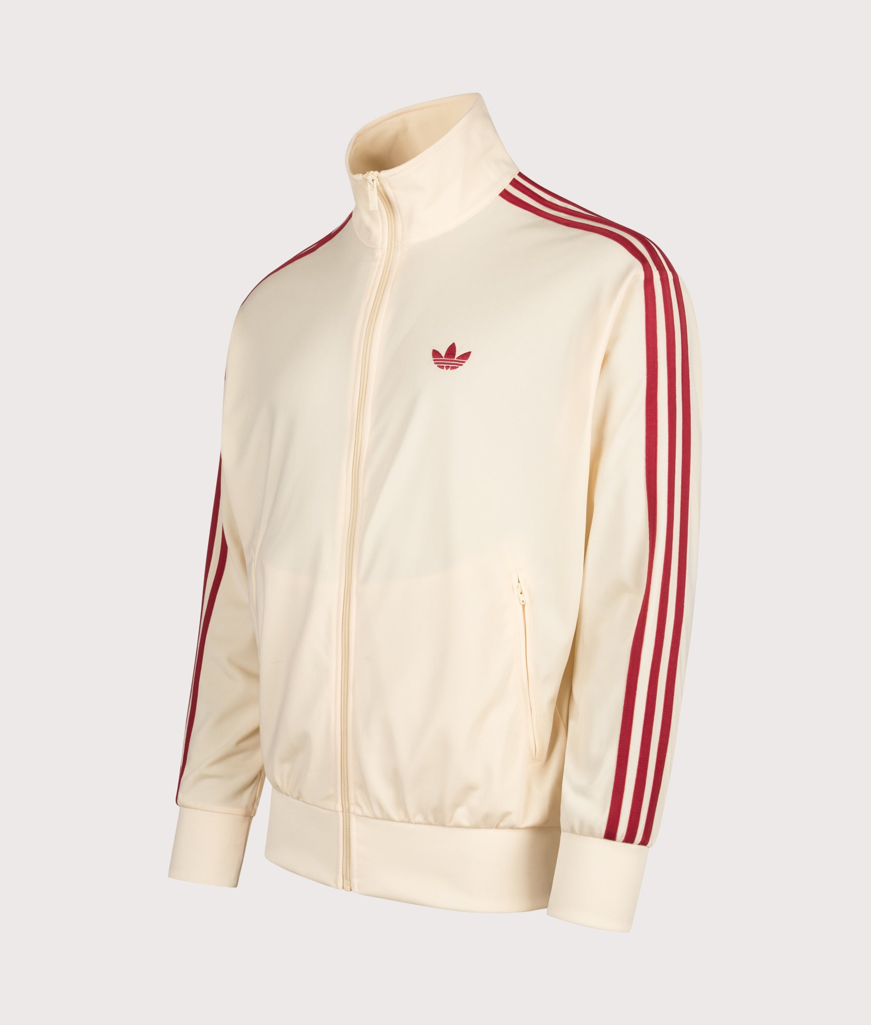 adidas Originals Loose Fit Firebird Track  in Warm Vanilla and Team Victory Red at EQVVS Menswear. Angled front shot.