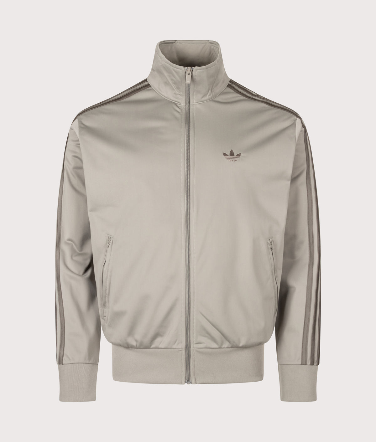adidas Originals Loose Fit Firebird Track Top in Silver Pebble at EQVVS Menswear. Front shot.