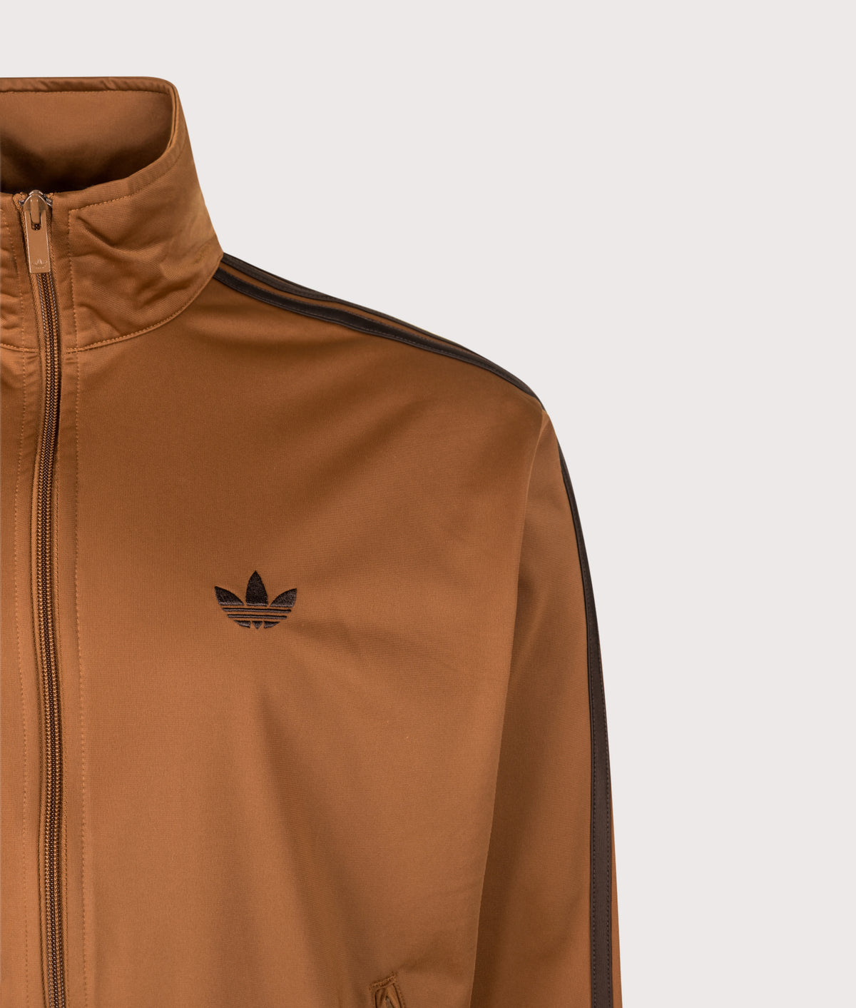 adidas Originals Loose Fit Firebird Track Top in Dusky Bronze and Aurora Coffee at EQVVS Menswear. Detail shot.