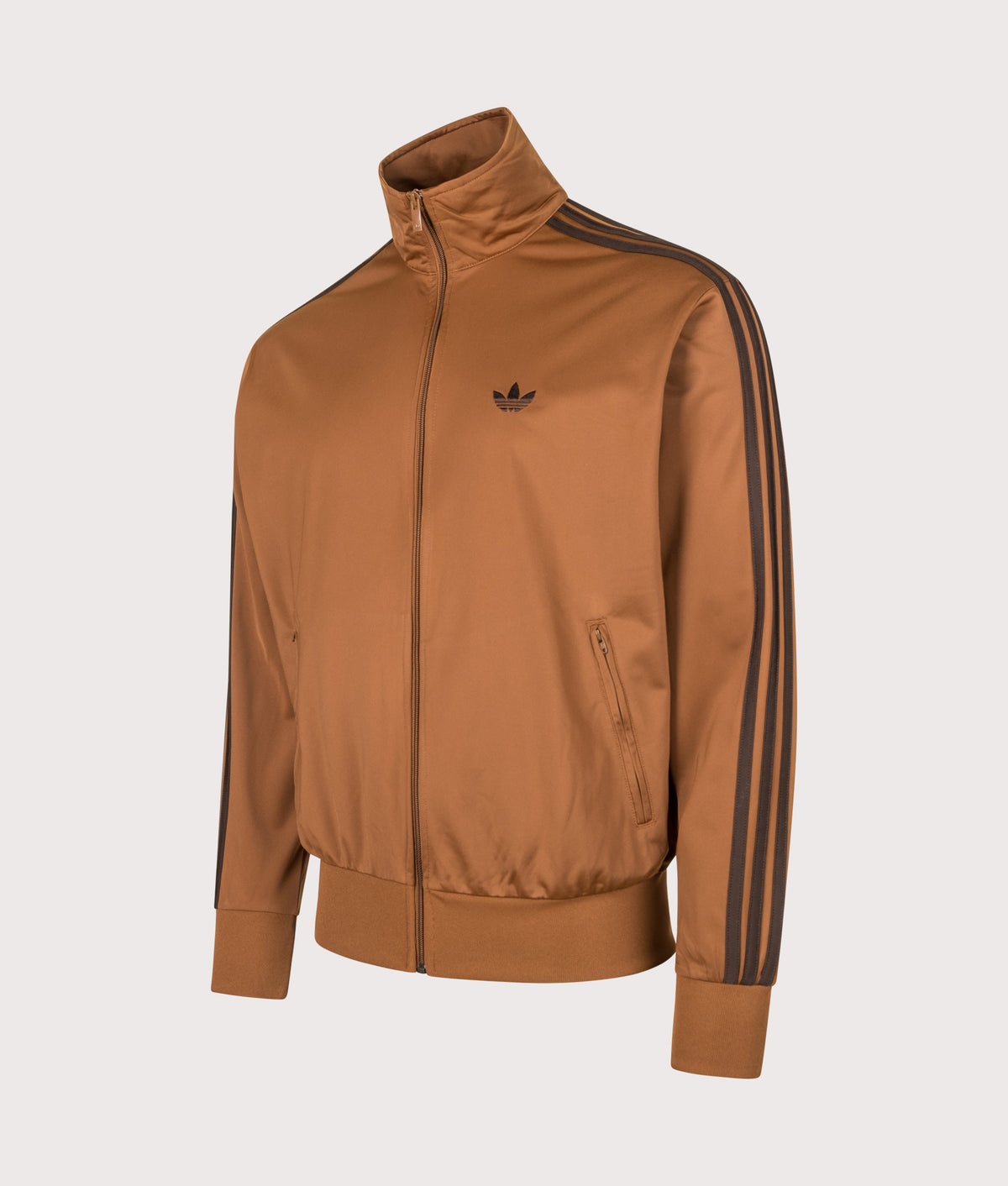 adidas Originals Loose Fit Firebird Track Top in Dusky Bronze and Aurora Coffee at EQVVS Menswear. Angled front shot.