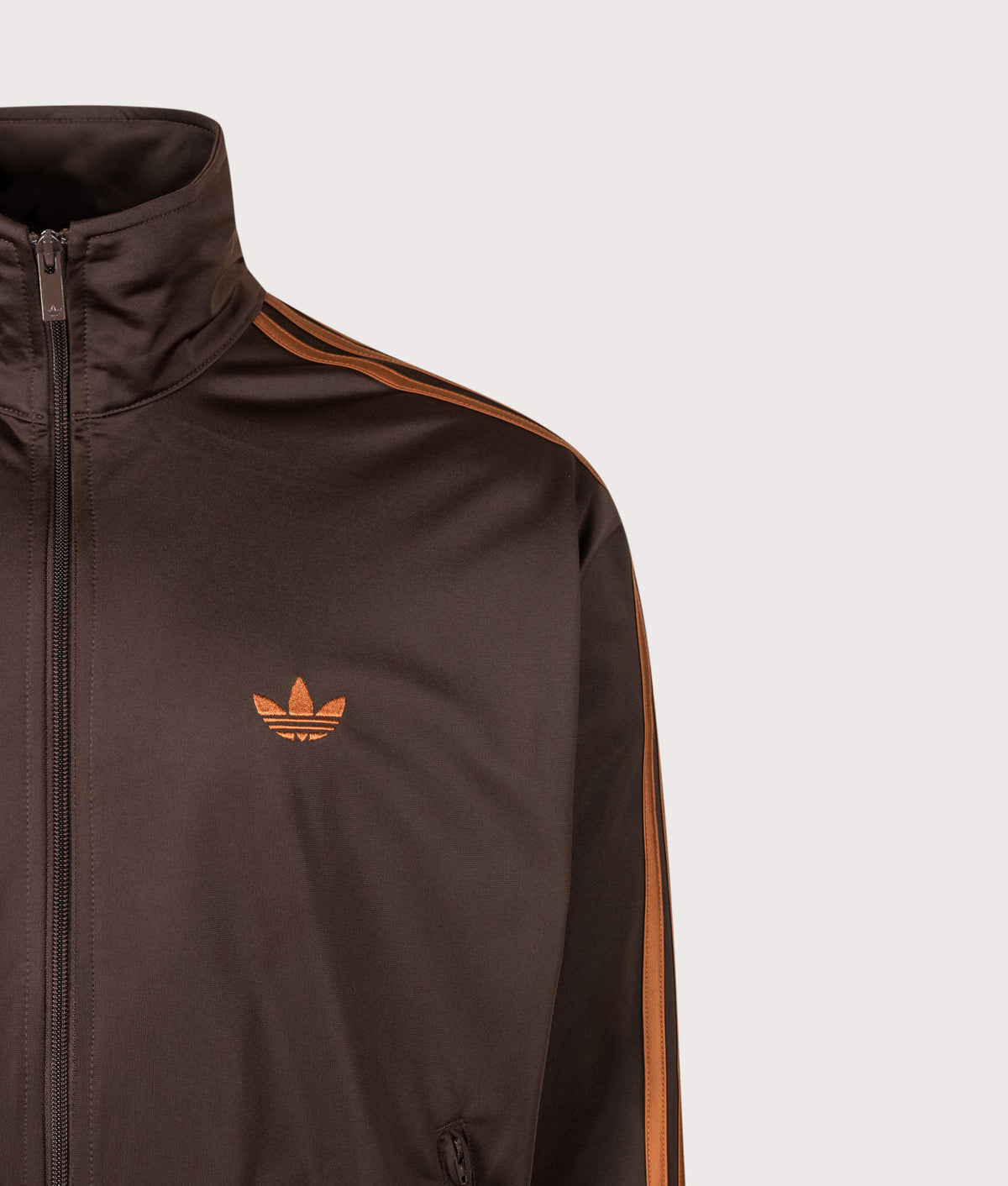 adidas Originals Loose Fit Firebird Track Top in Aurora Coffee and Dusky Bronze at EQVVS Menswear. Detail shot.
