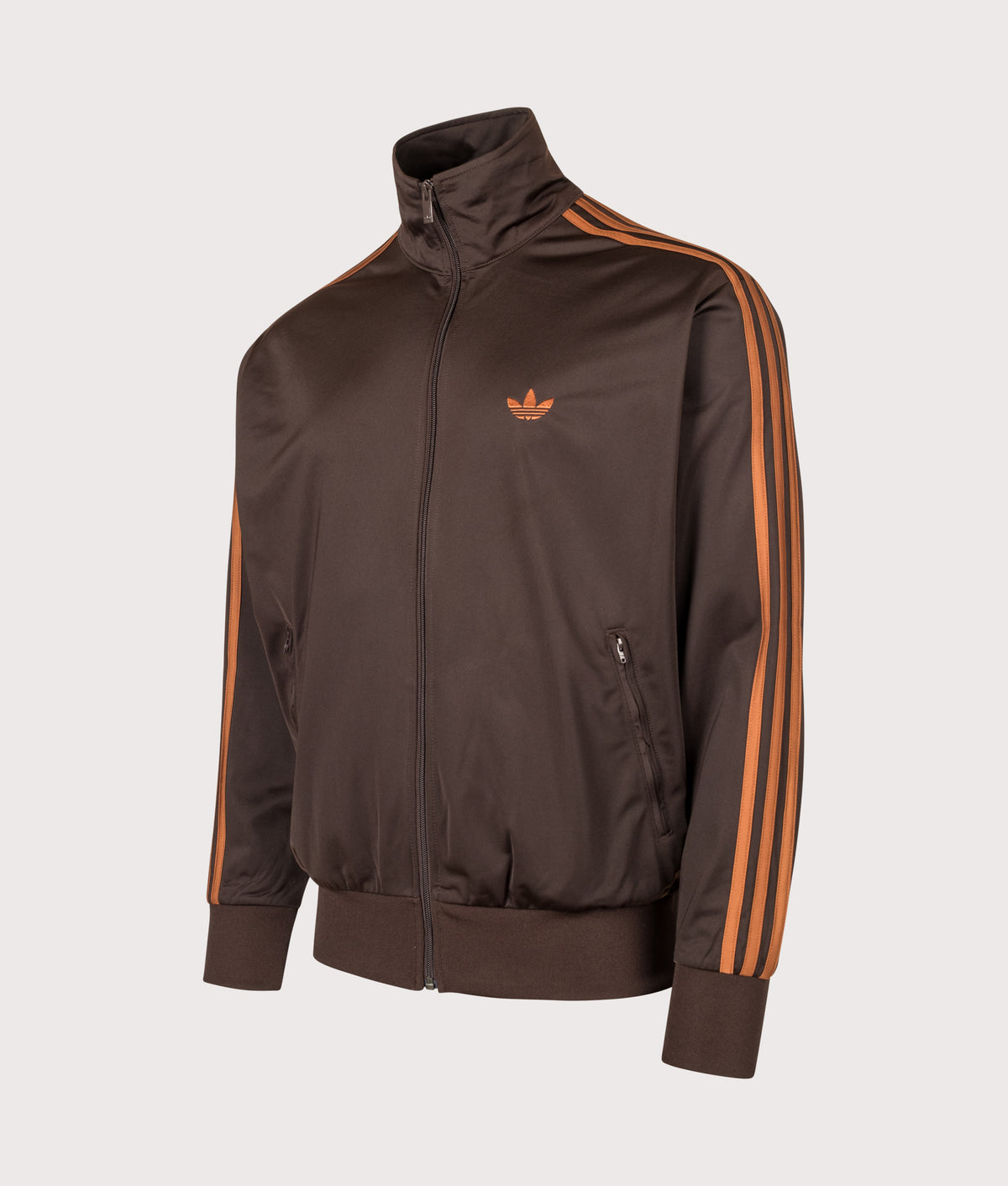 adidas Originals Loose Fit Firebird Track Top in Aurora Coffee and Dusky Bronze at EQVVS Menswear. Angled front shot.