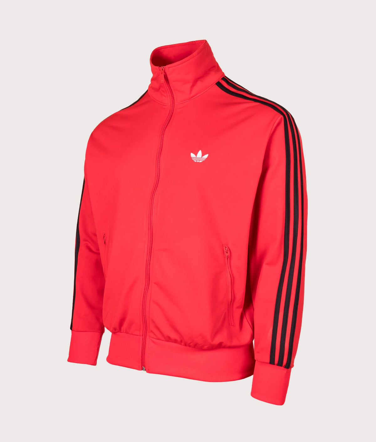 adidas Originals Loose Fit Firebird Track Top in Vivid Red at EQVVS Menswear. Angled front shot.