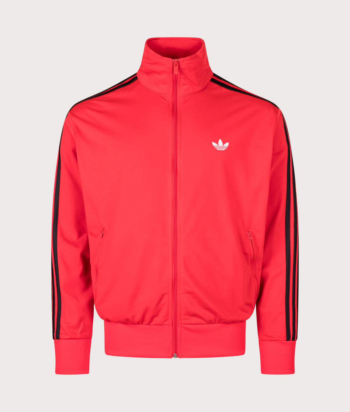 adidas Originals Loose Fit Firebird Track Top in Vivid Red at EQVVS Menswear. Angled front shot.