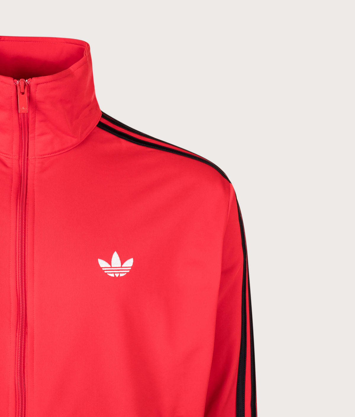 adidas Originals Loose Fit Firebird Track Top in Vivid Red at EQVVS Menswear. Detail shot.