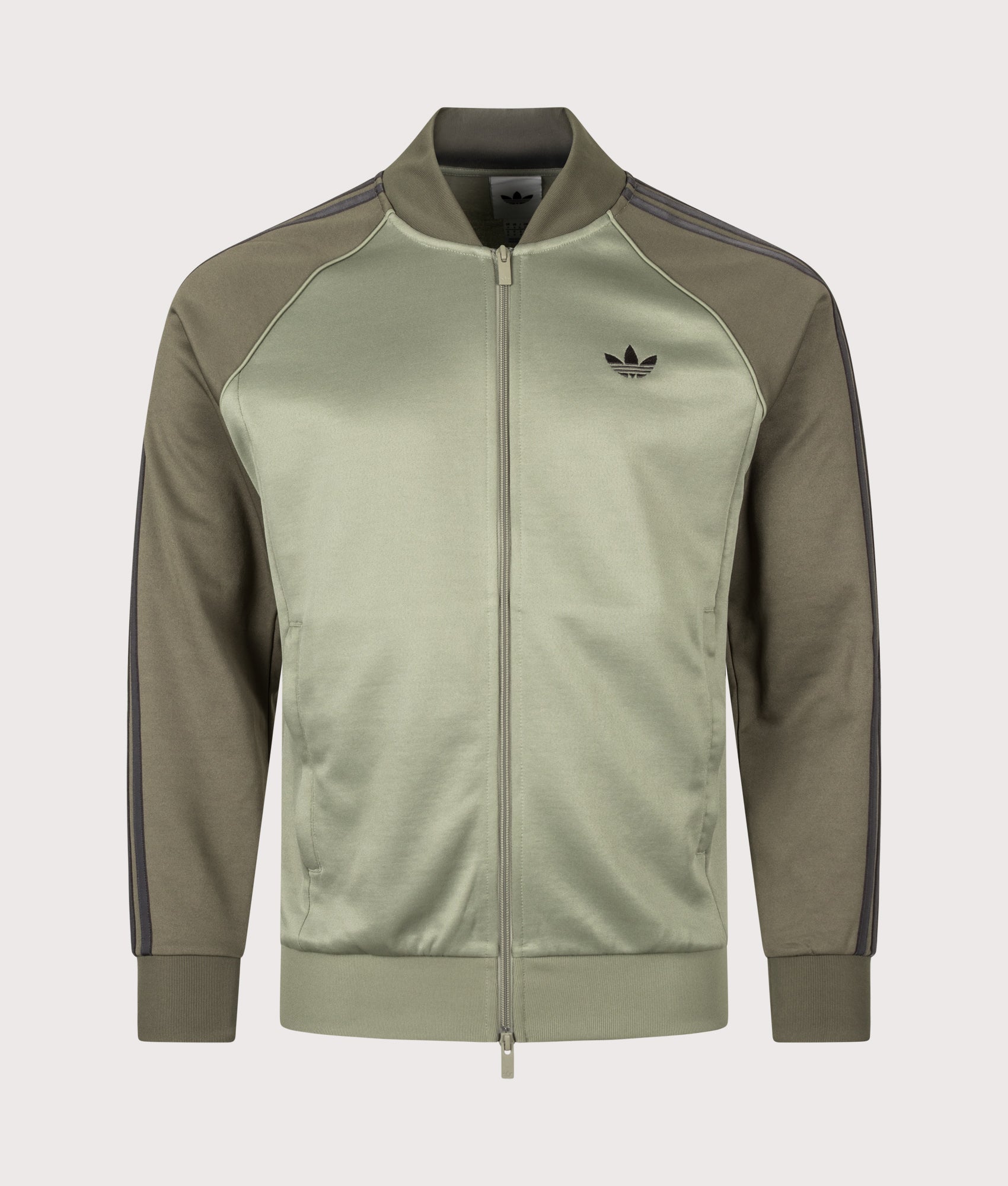 adidas Originals SST Track Top in Silver Pebble at EQVVS Menswear. Front shot.
