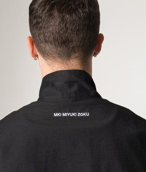 Track Jacket in Black | MKI MIYUKI ZOKU | Shot at EQVVS | Back detail model shot 