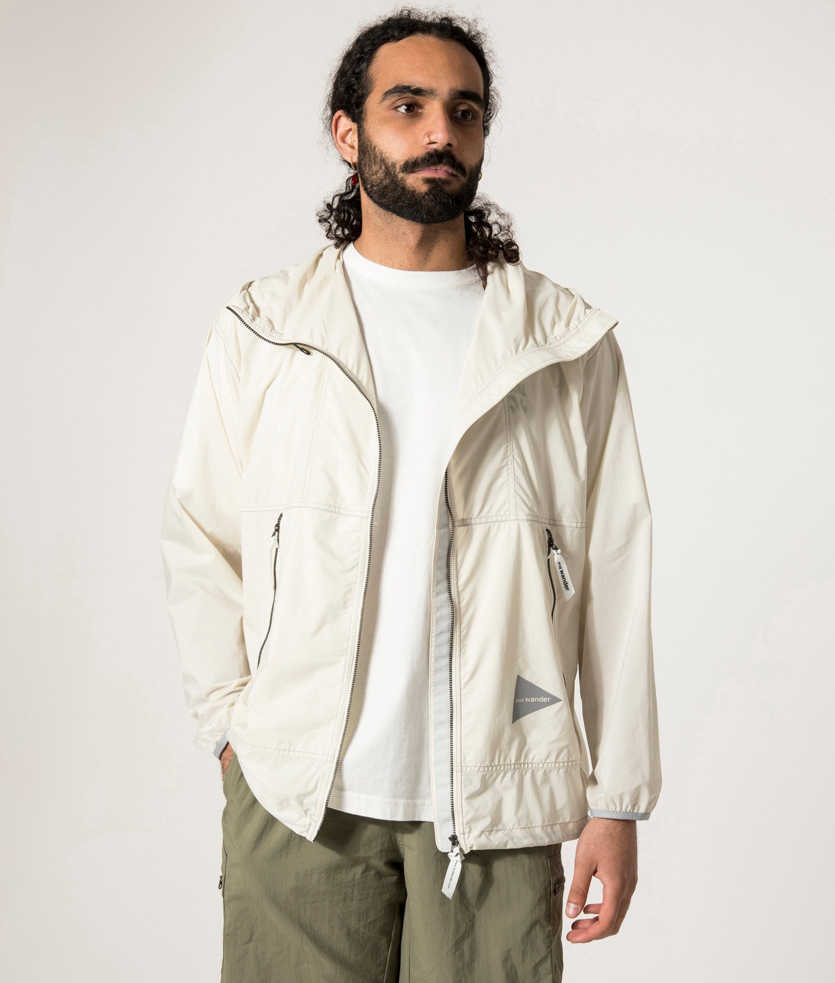 and wander Pertex Wind Jacket in Off White at EQVVS.  Open Jacket Model Shot.