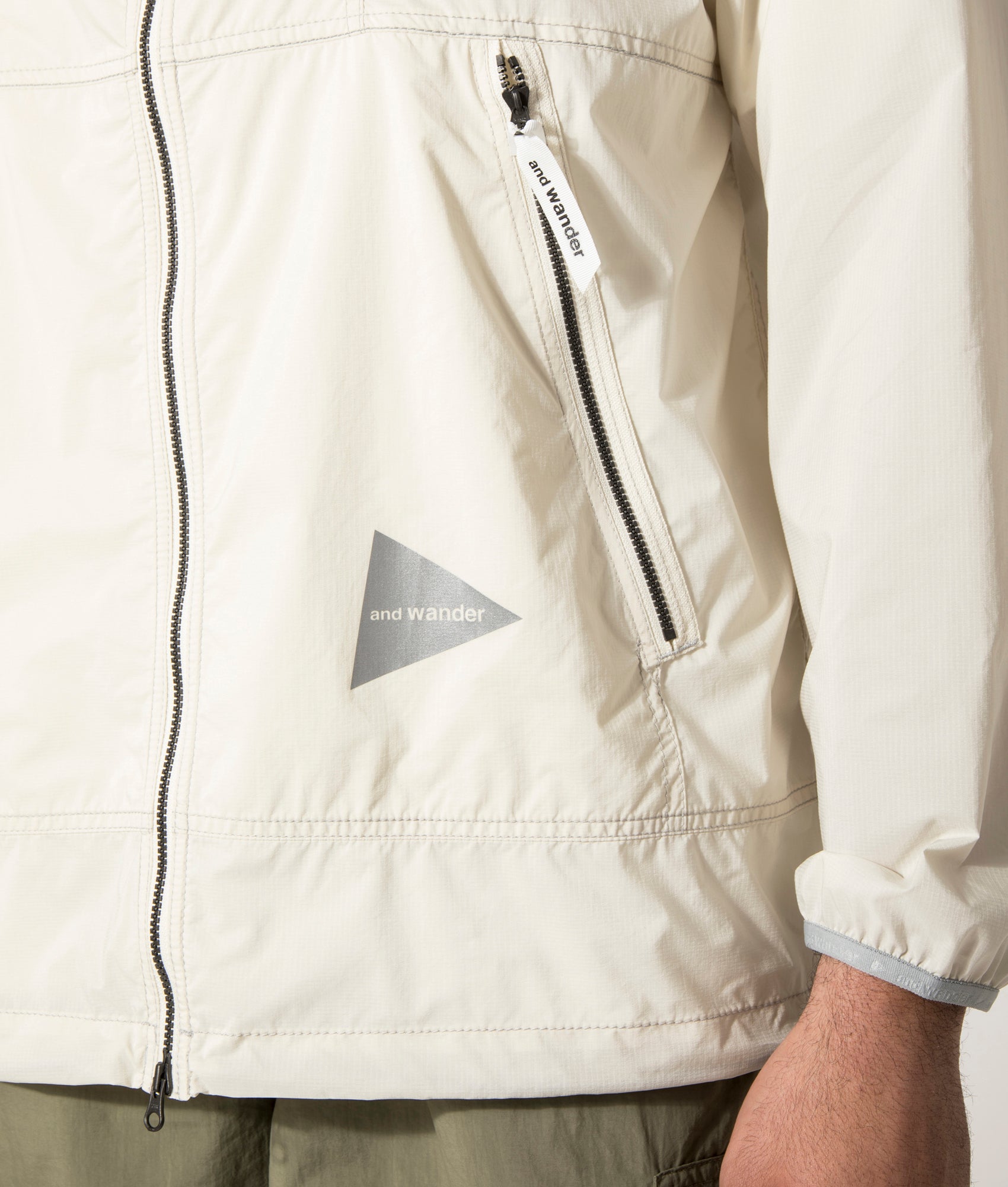 and wander Pertex Wind Jacket in Off White at EQVVS.  Detail Model Shot.